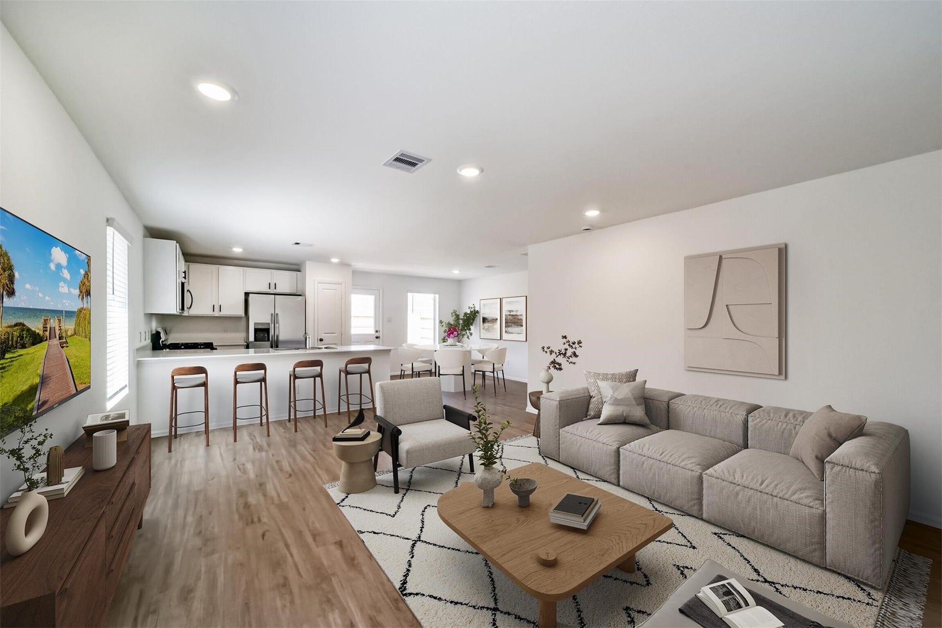 Beautiful open-concept living area connecting seamlessly to the kitchen on the left, featuring a large breakfast bar island with plenty of space for everyday living and entertaining.