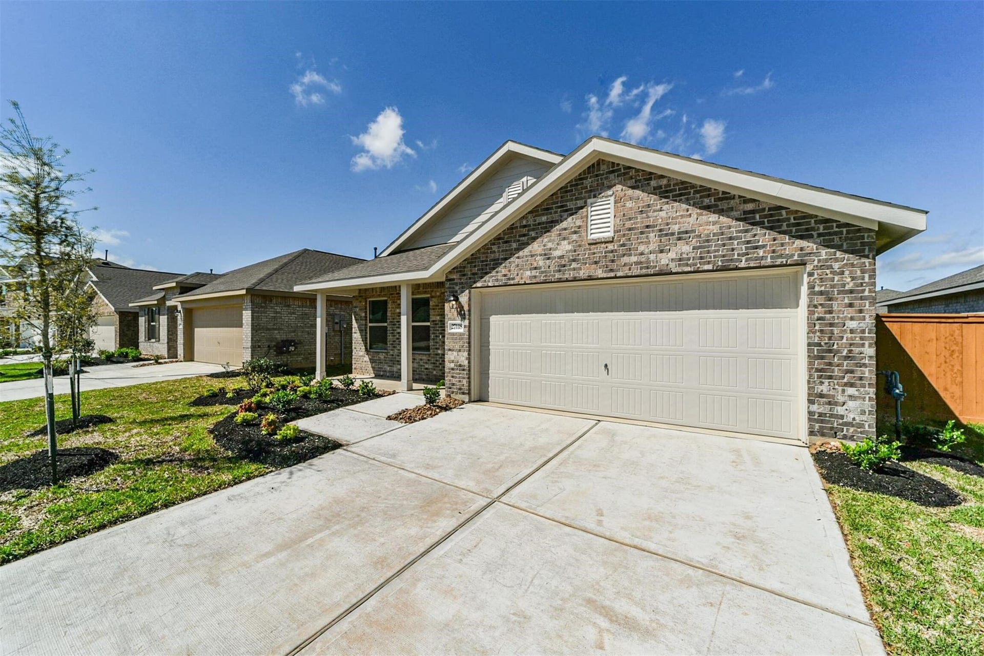 Alternative front exterior angle highlighting the driveway and modern architectural design.