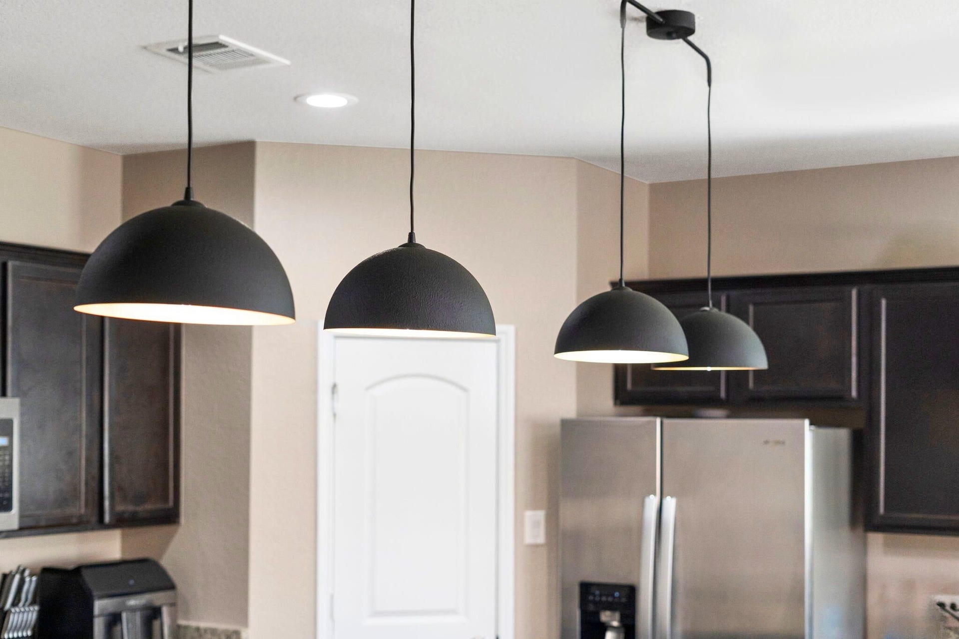 22624 Theodoli Drive, Katy, TX 77449 A stylish lighting fixture hangs over the kitchen island, adding a touch of elegance and highlighting the space