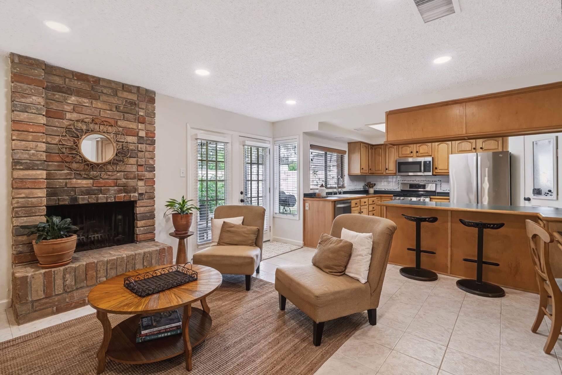 1802 Brushy Creek Drive, Sugar Land, TX 77478 The comfortable floor plan features a cozy gas-log fireplace, custom built-in cabinetry, and a family room that opens to the kitchen, creating an ideal space for everyday living and entertaining.