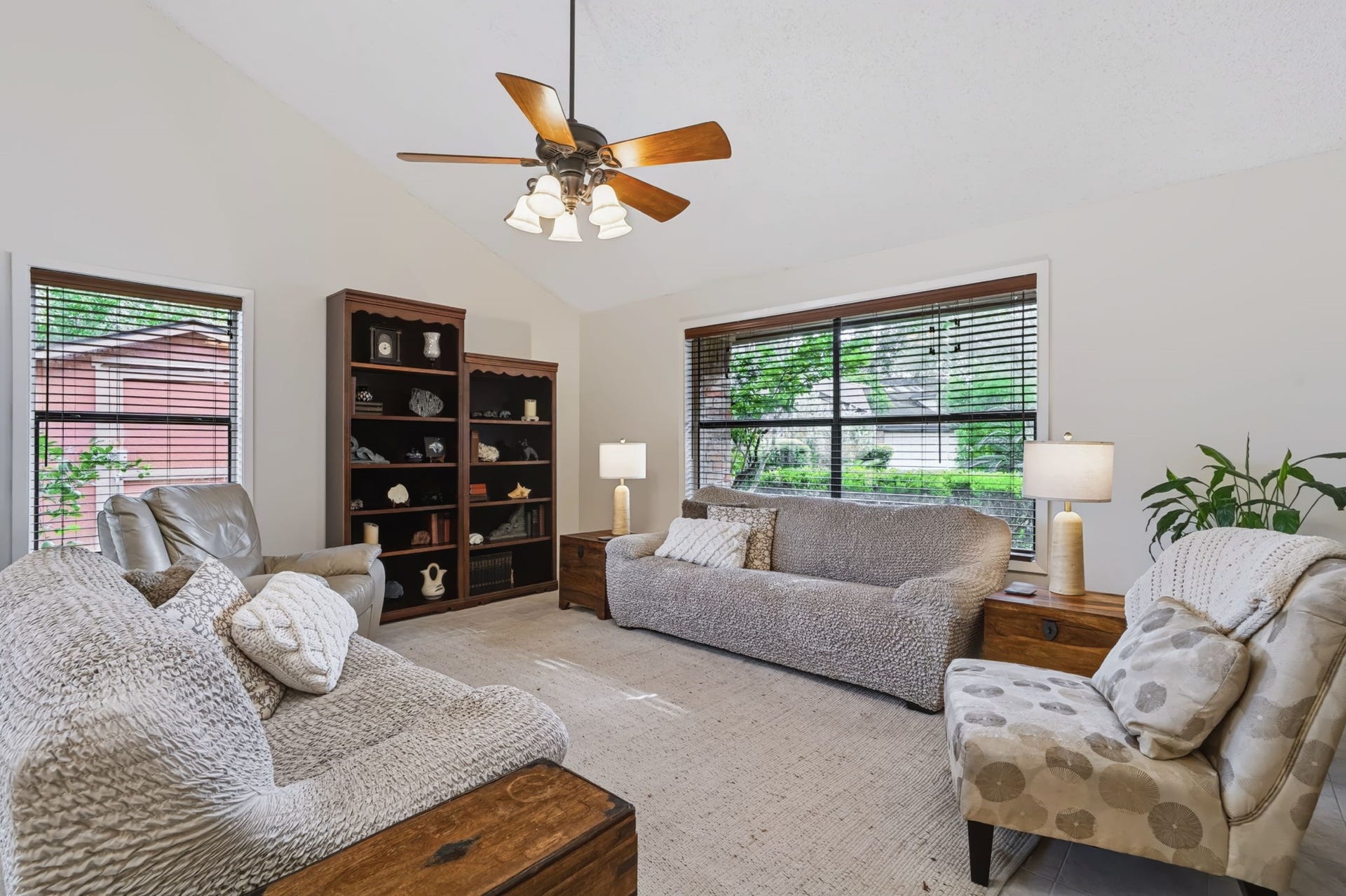 1802 Brushy Creek Drive, Sugar Land, TX 77478 Soaring ceilings and large windows create a bright, open atmosphere in the living room.