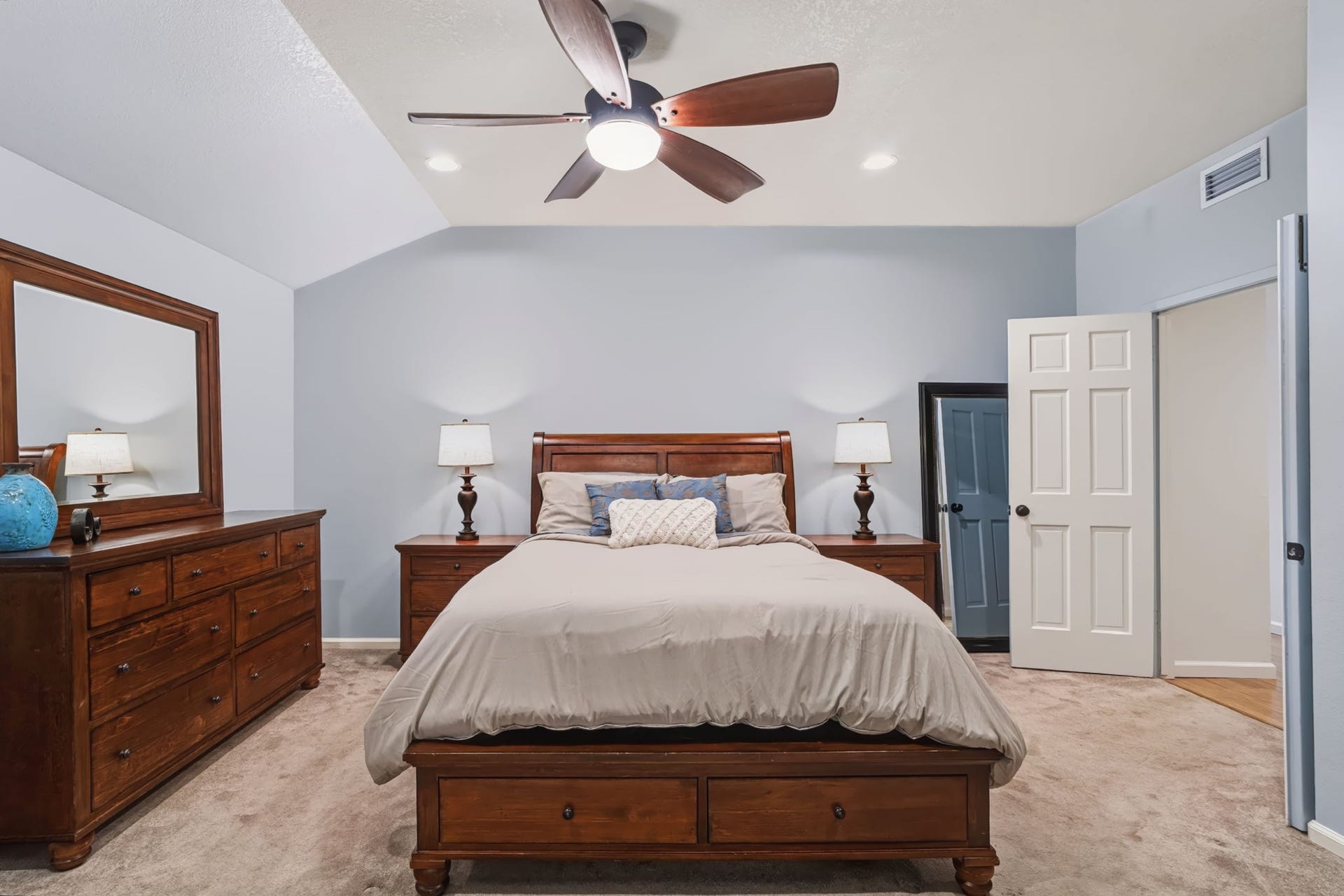 1802 Brushy Creek Drive, Sugar Land, TX 77478 Double doors welcome you into the primary bedroom, featuring recessed lighting, a lighted ceiling fan, and soft, neutral-toned carpeting for a relaxing retreat.