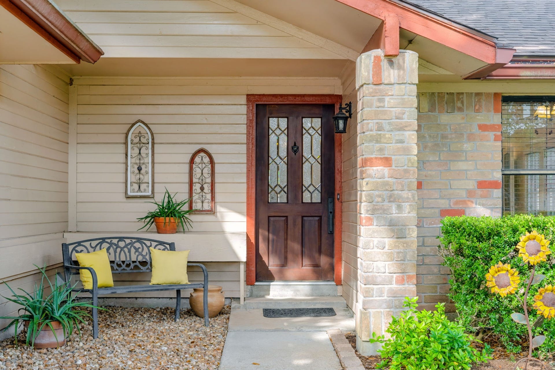 1802 Brushy Creek Drive, Sugar Land, TX 77478 A covered front entrance welcomes you with a beautiful wood and leaded glass front door, creating an inviting first impression with timeless character.