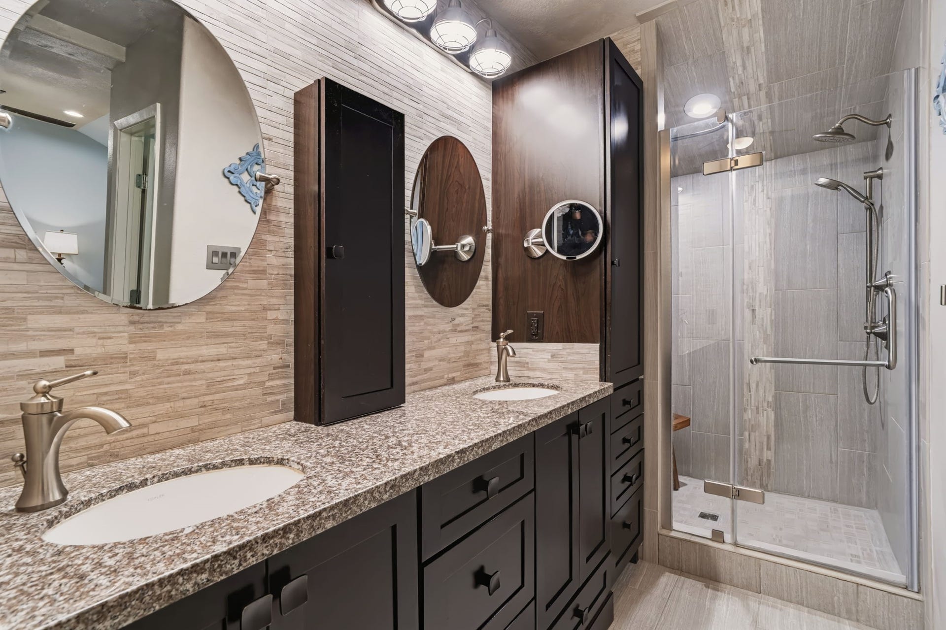 1802 Brushy Creek Drive, Sugar Land, TX 77478 The renovated primary bath features a large dual vanity with generous storage and a frameless glass walk-in shower, complete with a rain showerhead and handheld sprayer for a spa-like experience. The adjoining walk-in closet offers built-in storage to keep everything organized.