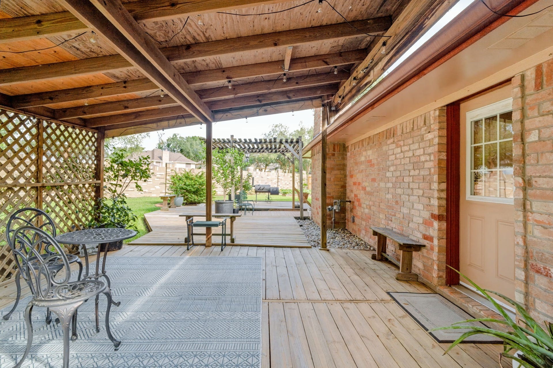 1802 Brushy Creek Drive, Sugar Land, TX 77478 Step outside to enjoy the covered patio overlooking the beautifully landscaped backyard and side yard.