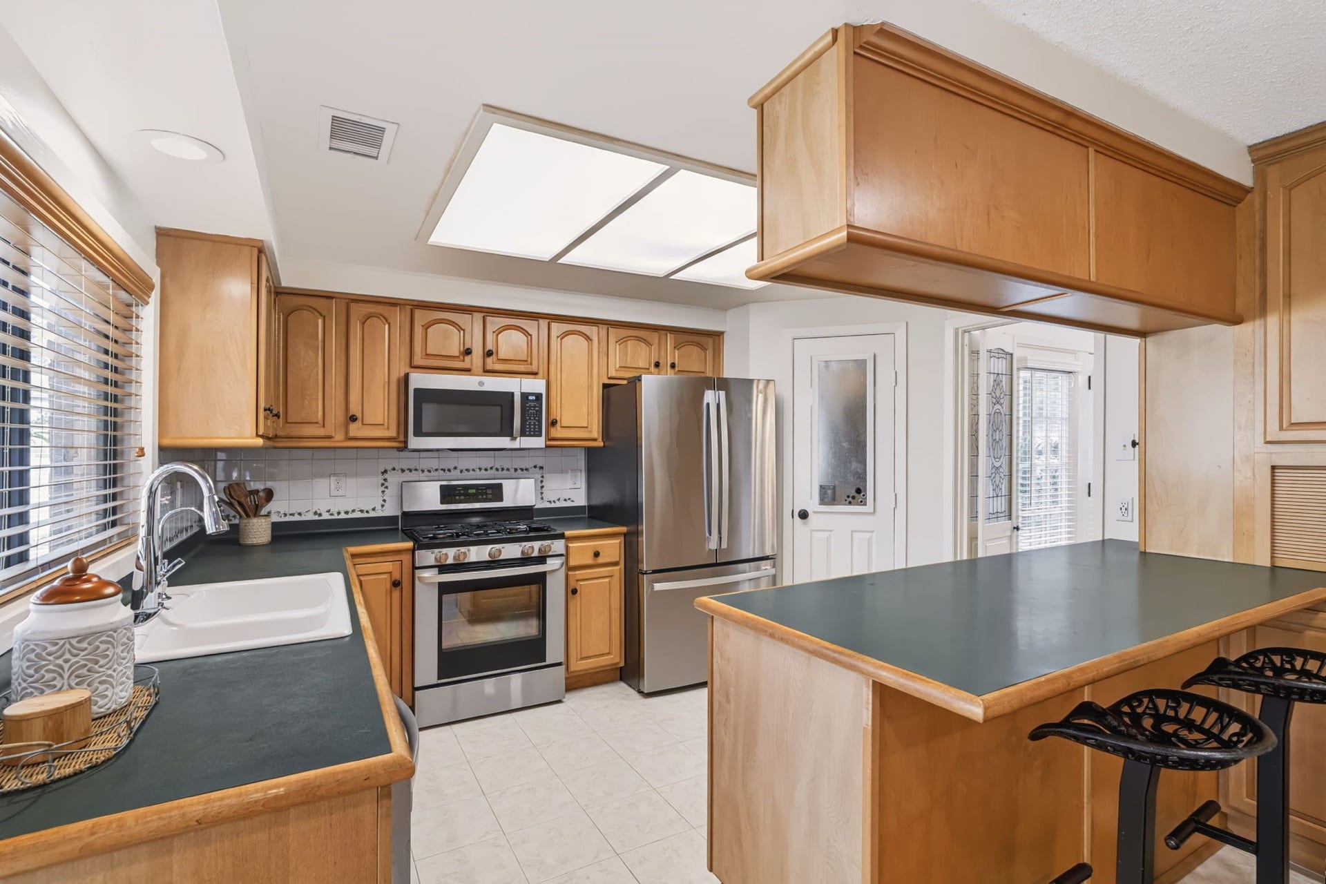 1802 Brushy Creek Drive, Sugar Land, TX 77478 A walk-in pantry tucked beside the refrigerator provides additional storage.