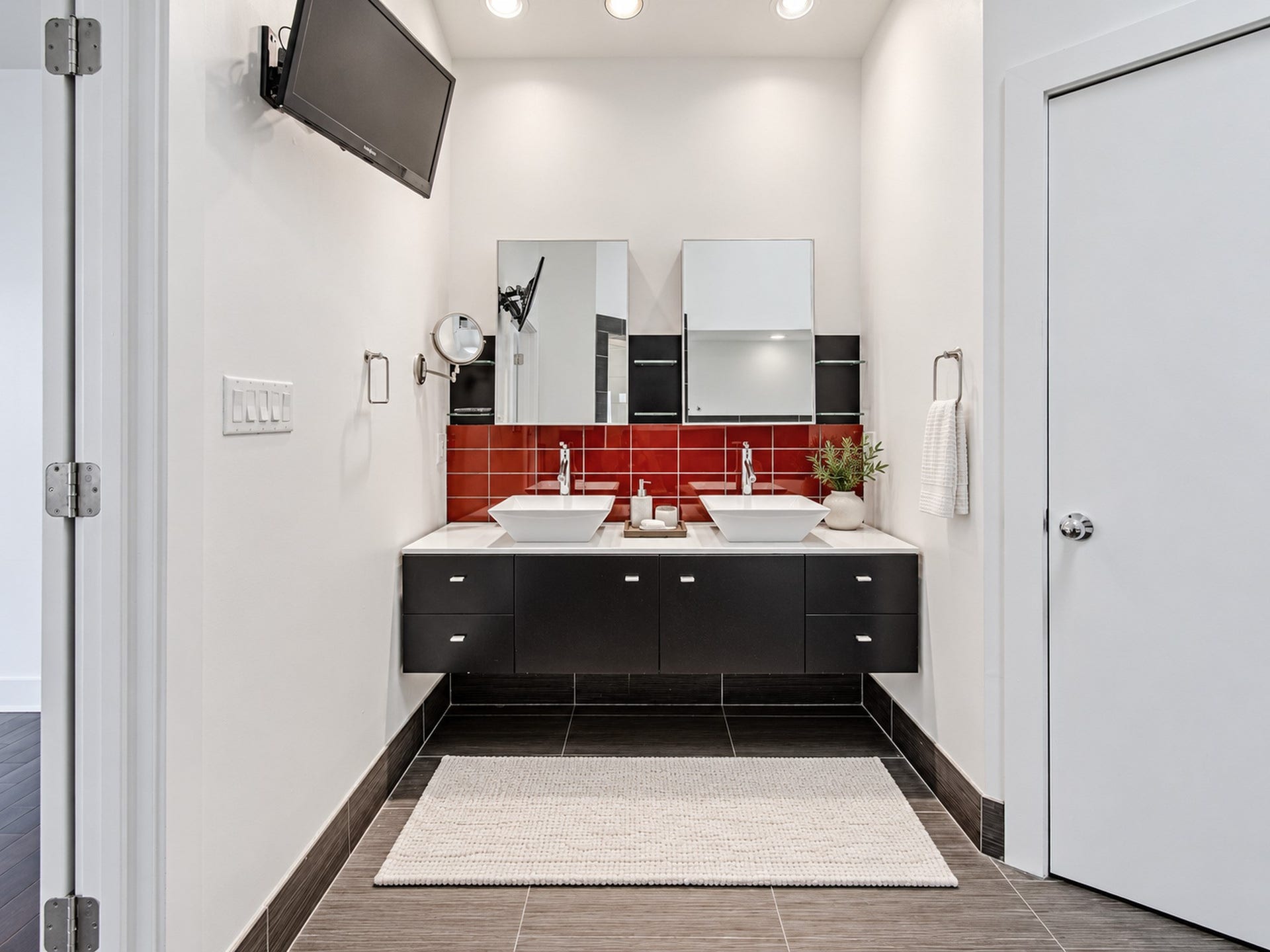 2025 Colquitt Street, #E, Houston, TX 77098 Additional view of the primary bathroom highlighting its floating vanity, mirrored storage, and contrasting finishes.