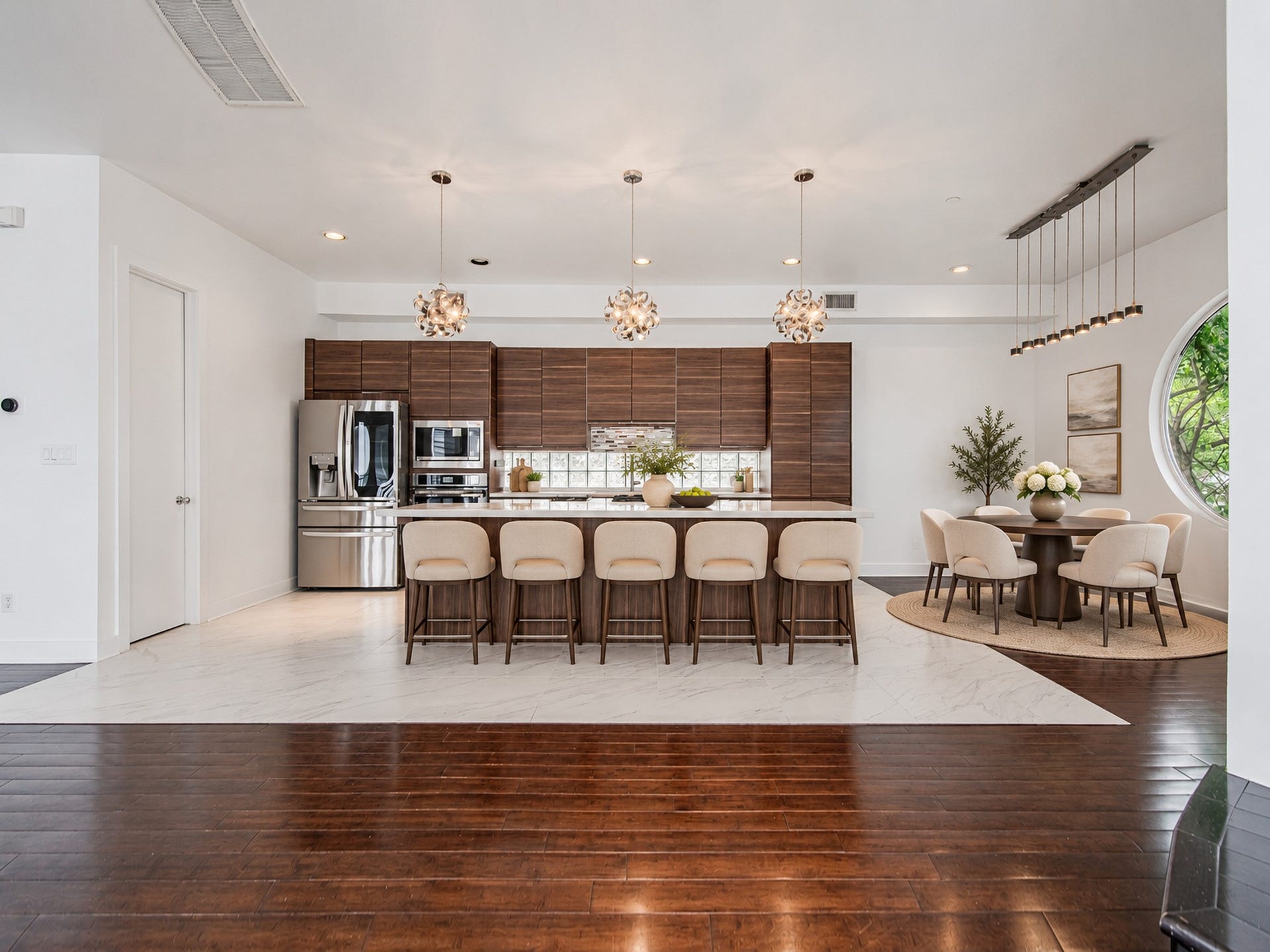 2025 Colquitt Street, #E, Houston, TX 77098 Wide view of the kitchen showcasing generous island seating and an open layout connecting to the surrounding living space.