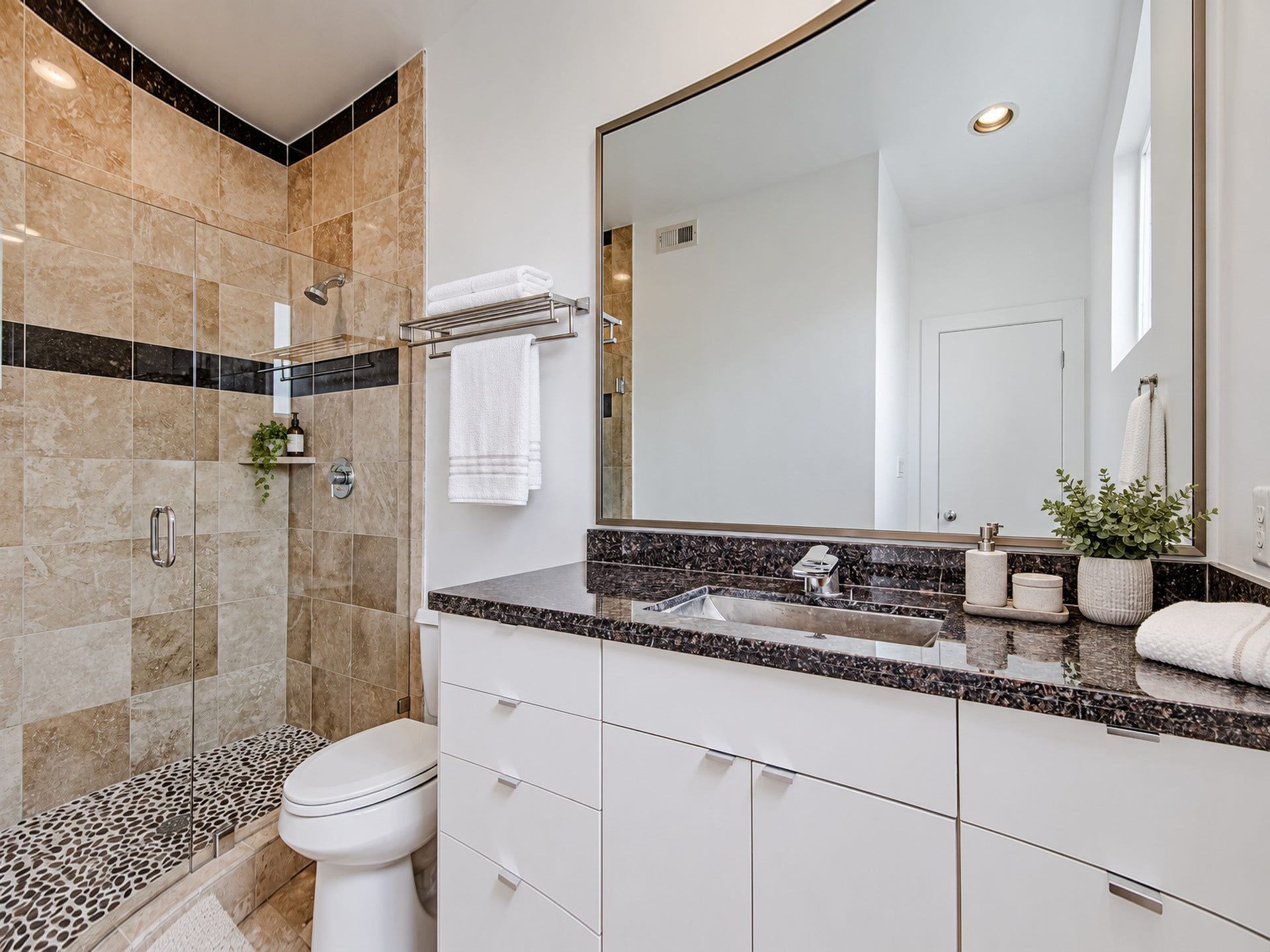 2025 Colquitt Street, #E, Houston, TX 77098 Secondary bathroom with white vanity cabinetry, a dark countertop, and a tiled tub and shower combination.