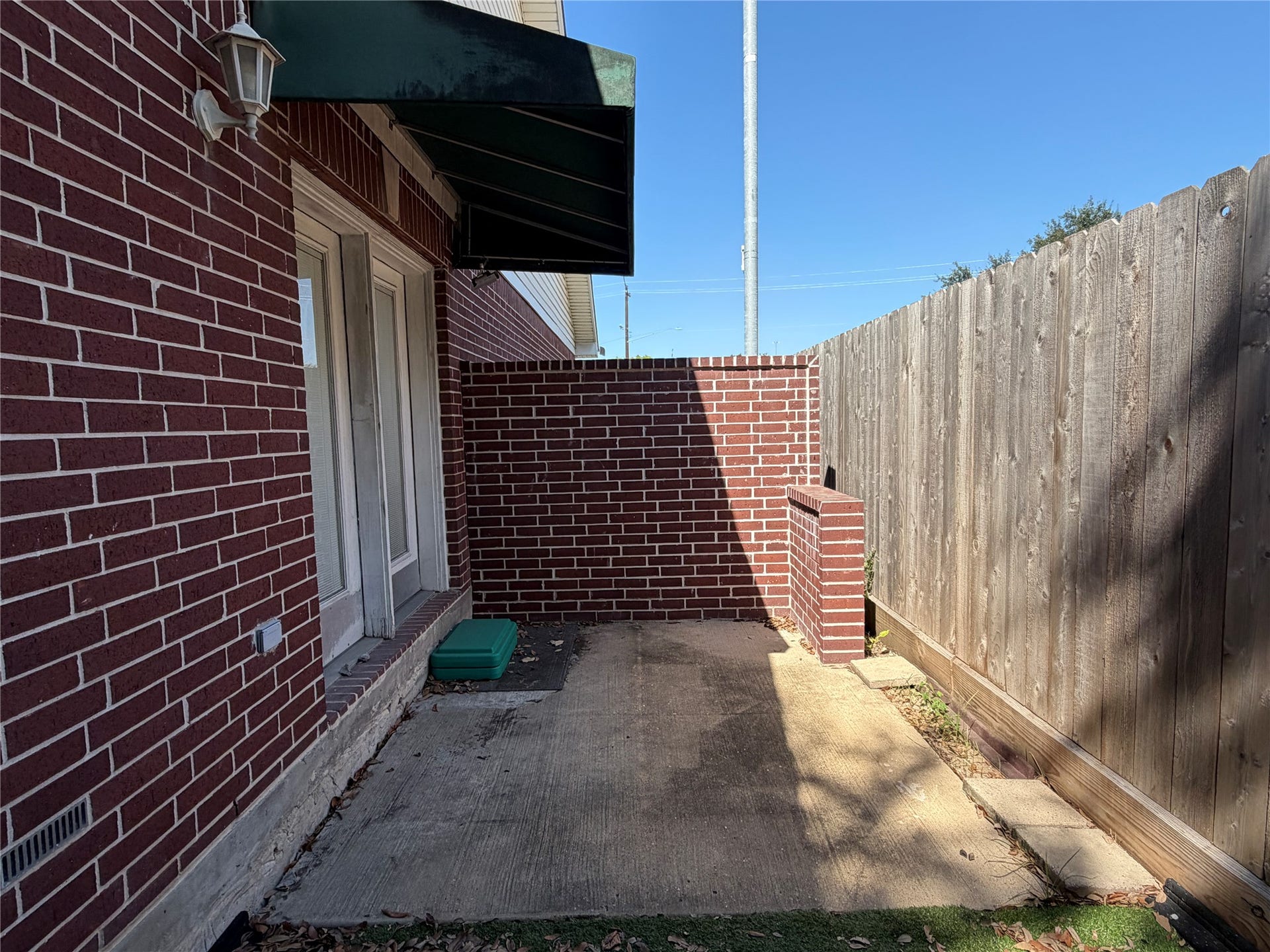 There is a partially covered patio just outside the back door.