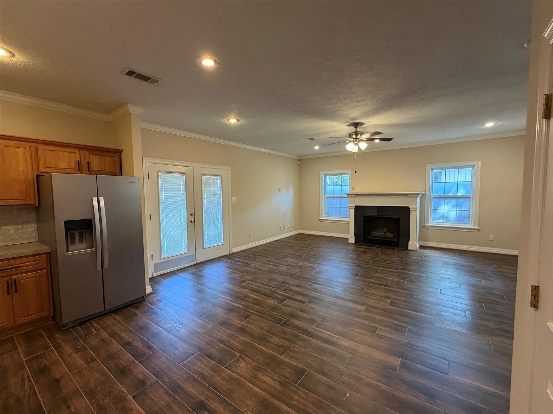 The kitchen features a new stainless-steel refrigerator.