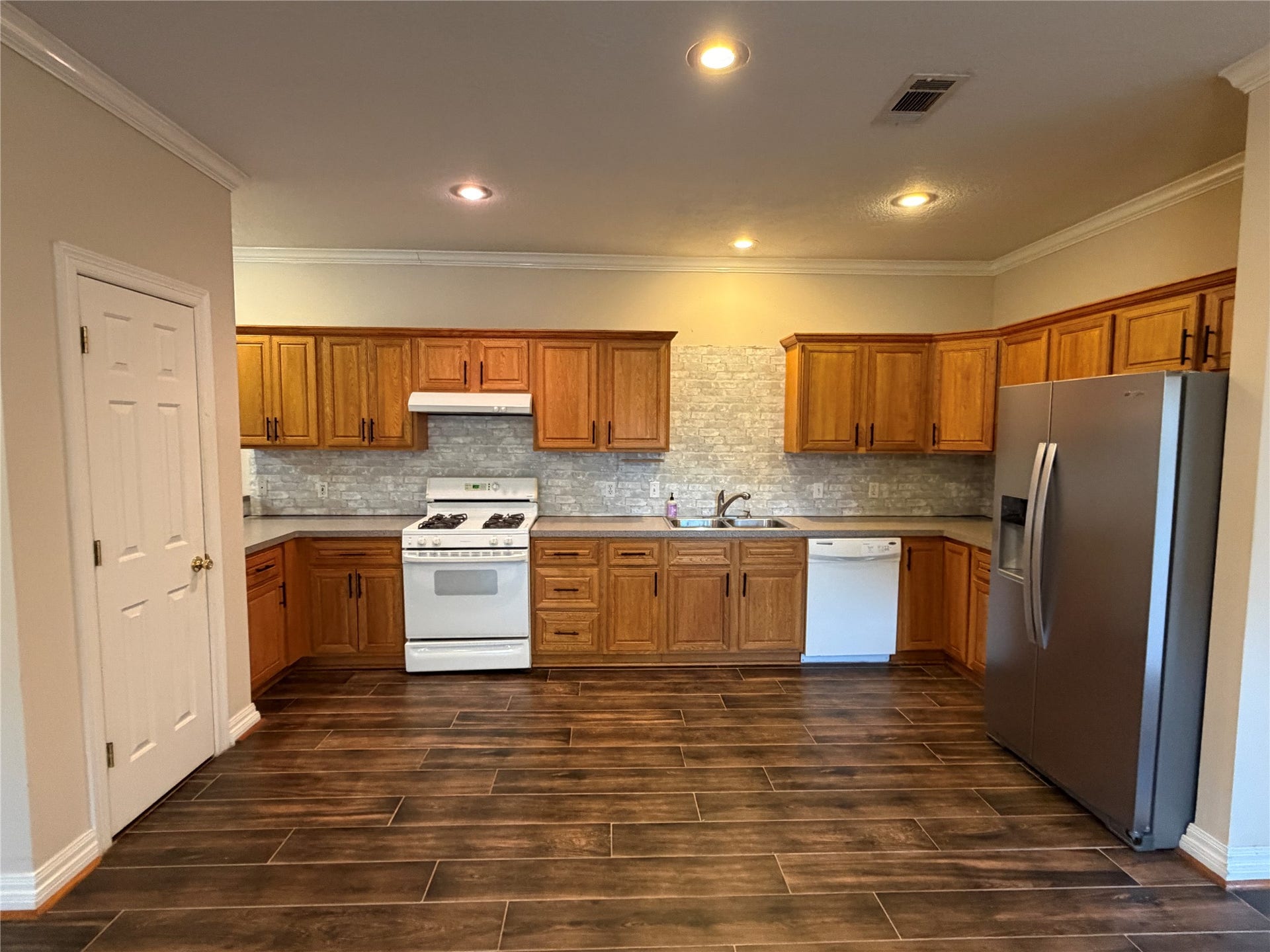 The kitchen has plenty of storage and a large pantry.