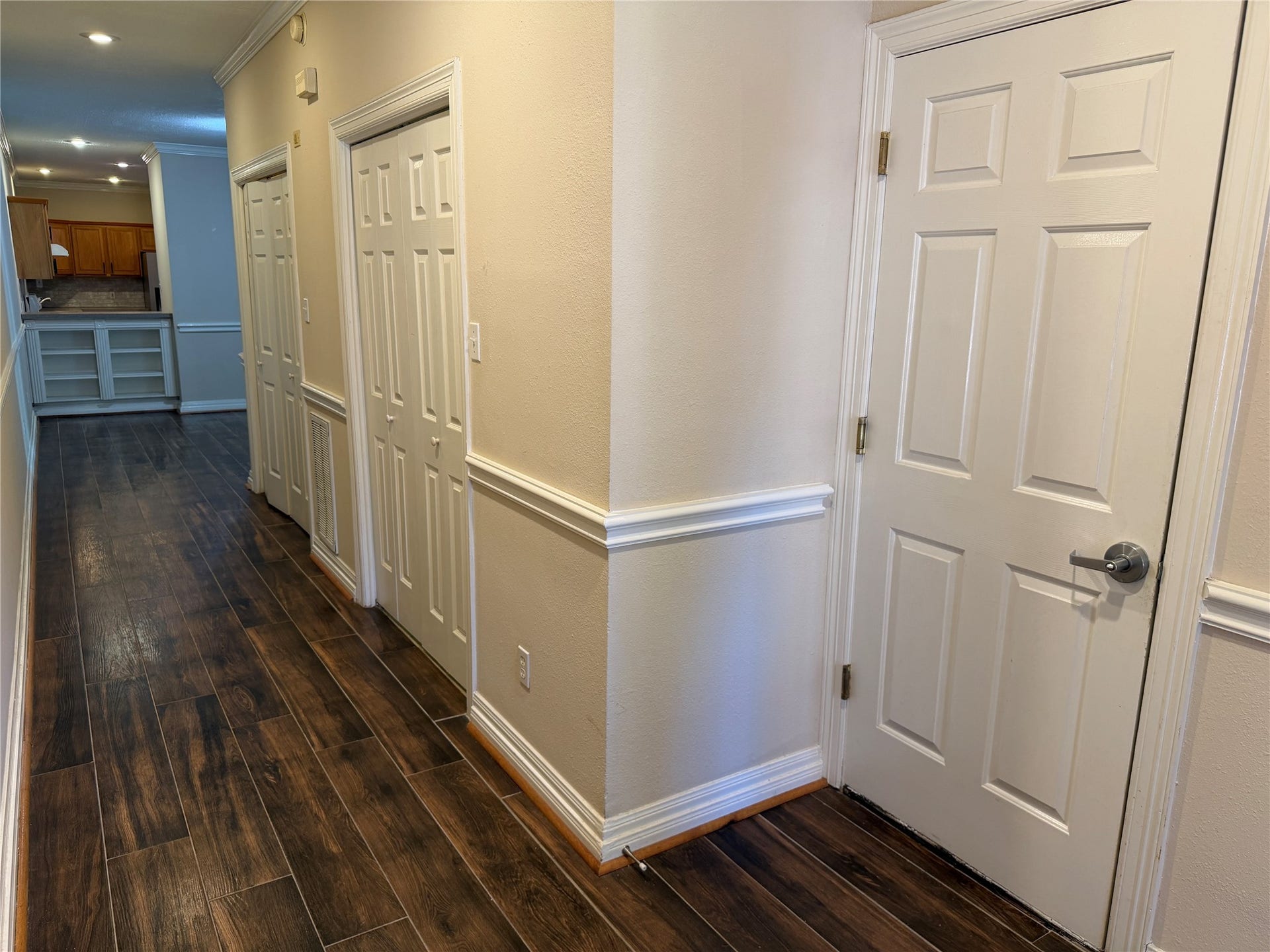 Upon entry to the home, you can see the easy to clean and sturdy vinyl plank floors, a storage closet and laundry room.