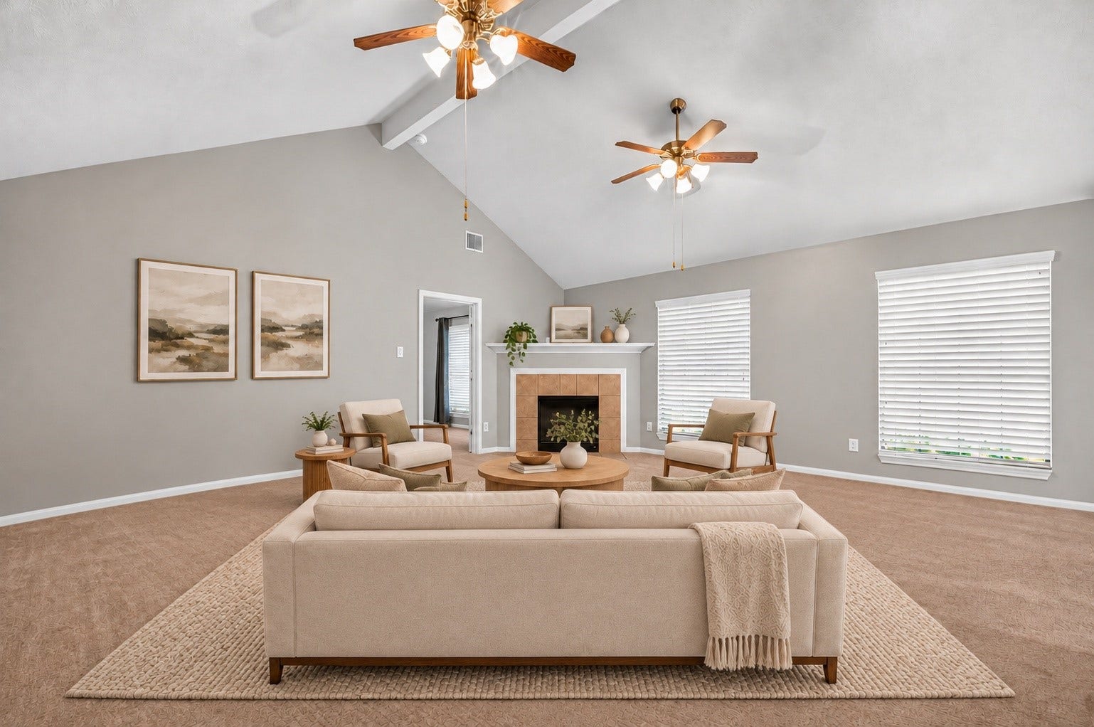 Virtually staged living area featuring a vaulted ceiling, two ceiling fans, a tile-surround fireplace, and large windows with white blinds.