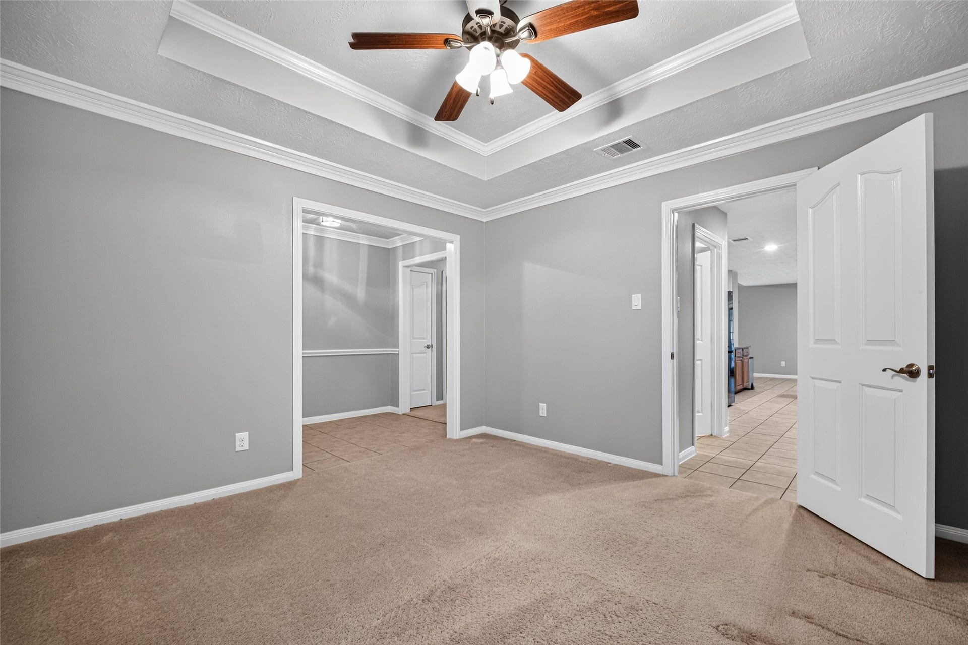 Additional view of the flex space highlighting recessed lighting, detailed ceiling, and open layout.