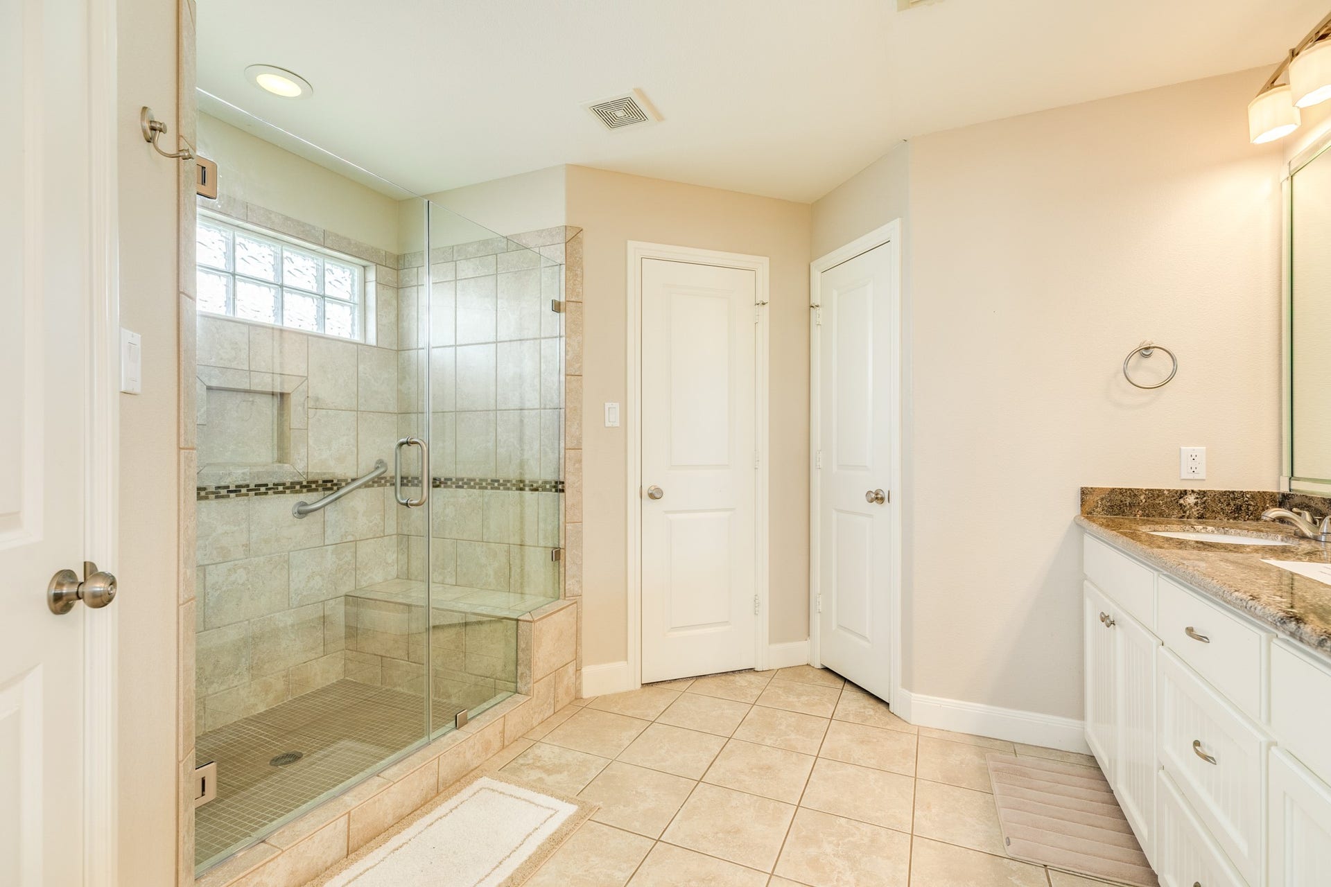 325 Admiral Circle, Tiki Island, TX 77554 View of the primary walk in shower, door to the left is 'her' closet and door next to this is the water closet.