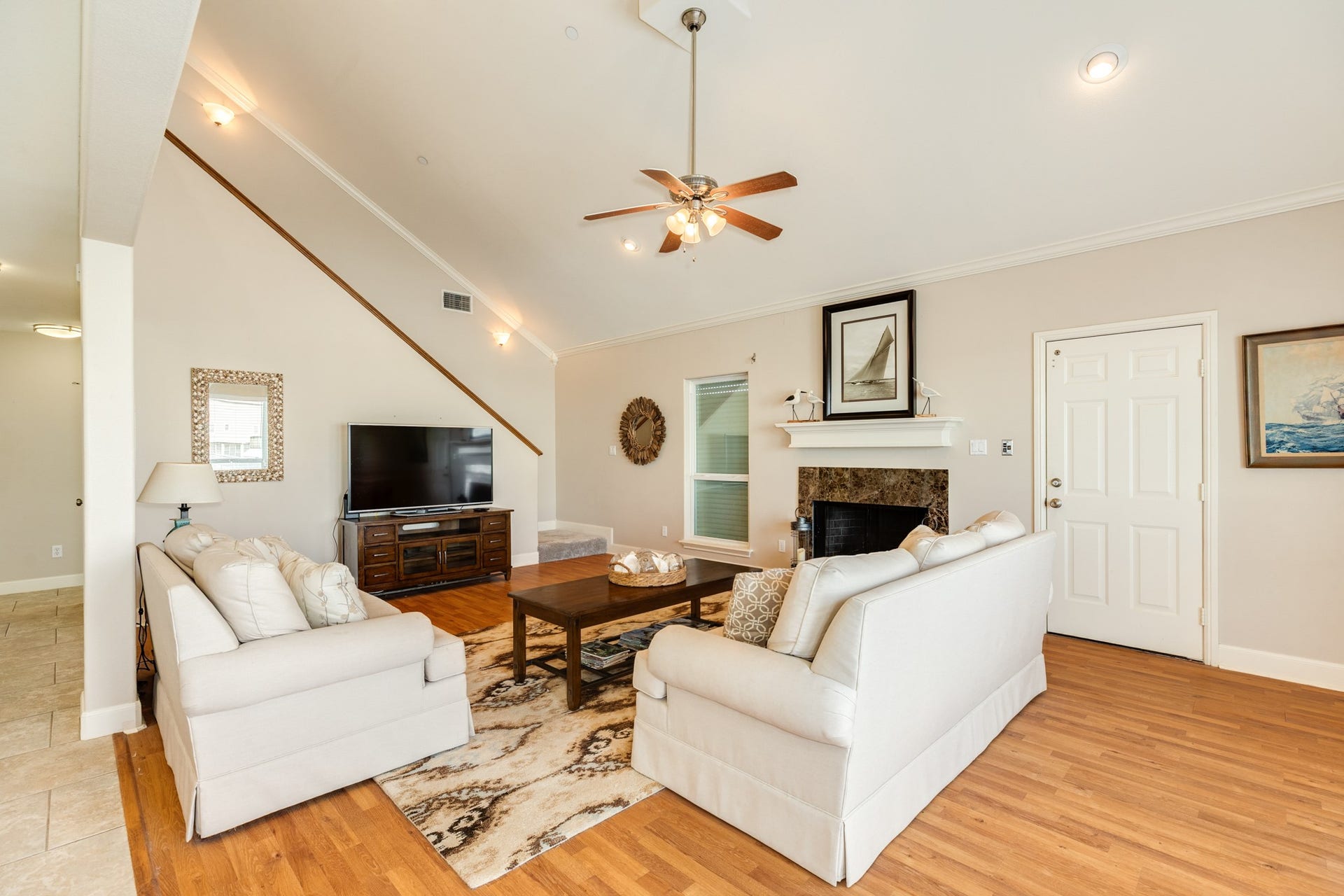 325 Admiral Circle, Tiki Island, TX 77554 Door in view next to the fireplace, is the elevator. Nice spacious living room for when you need a break from the outdoors.