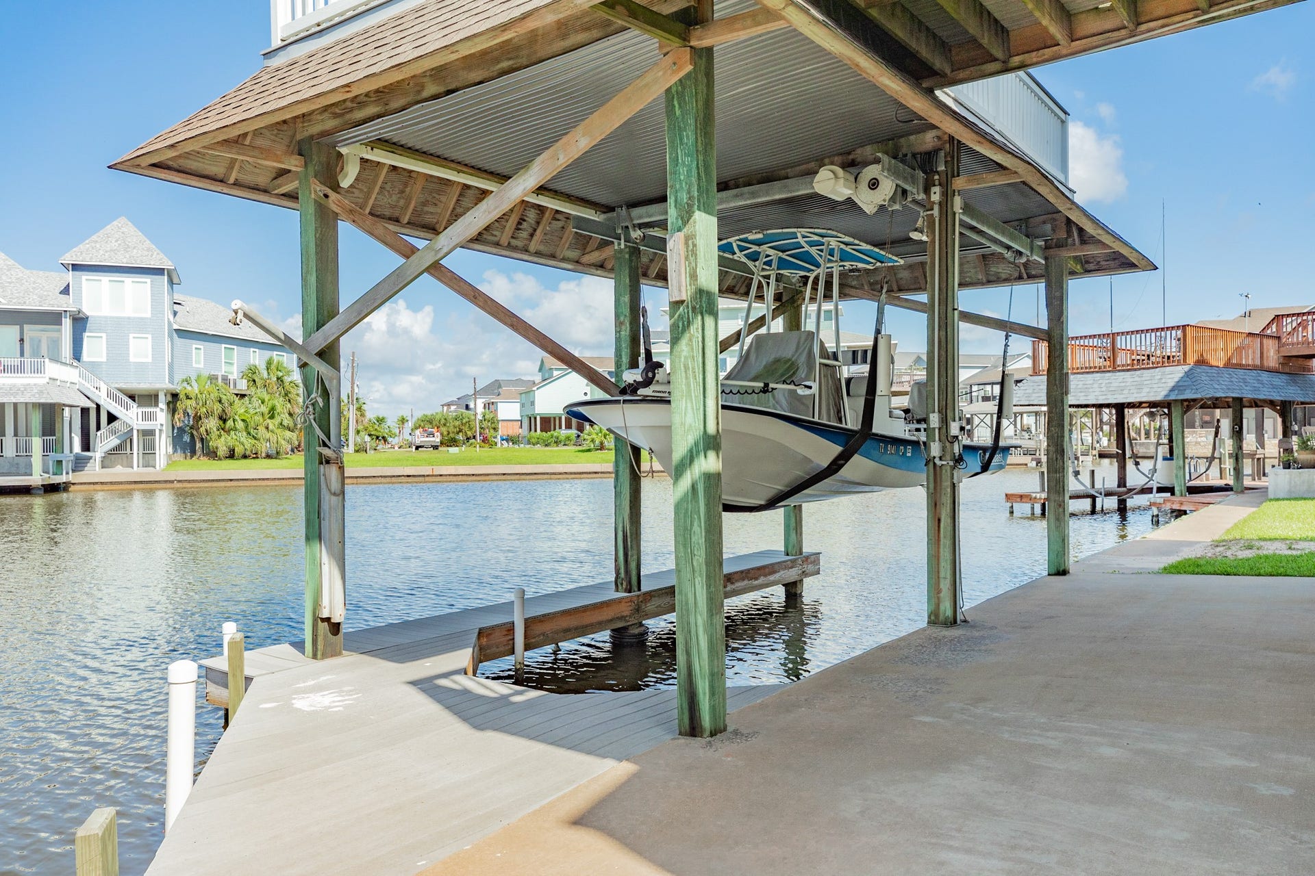 325 Admiral Circle, Tiki Island, TX 77554 Boat slip & lift allows you to get your boat, with fixed Bimini top, out of the water with plenty of room for when those high tides come in.