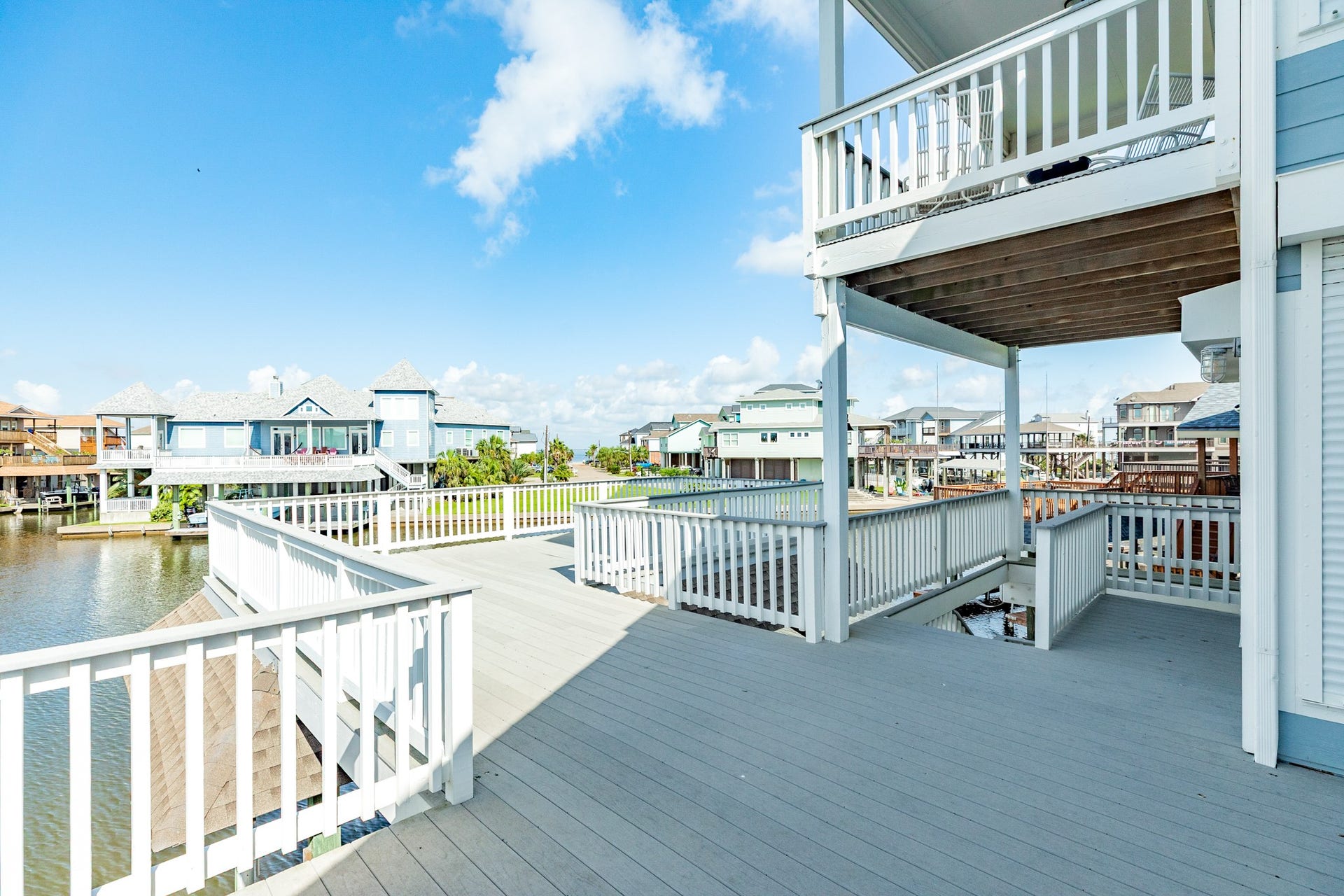 325 Admiral Circle, Tiki Island, TX 77554 Main deck provides over 500 sq ft of entertaining space and views of the bay and canals.