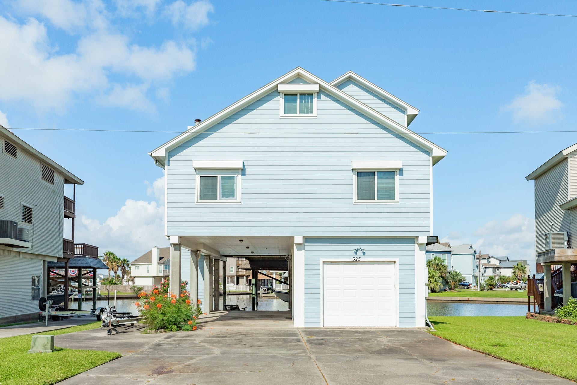 325 Admiral Circle, Tiki Island, TX 77554 Street view of home.