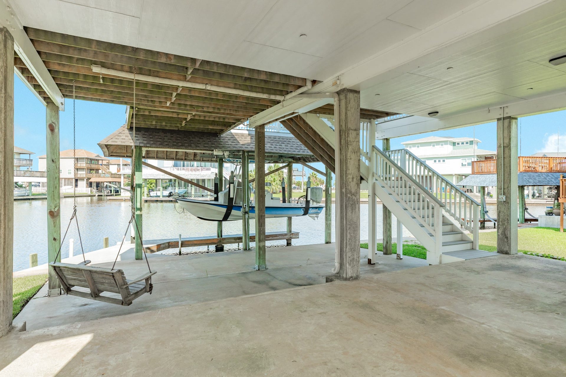 325 Admiral Circle, Tiki Island, TX 77554 Multi level concrete patio area leading down to the boat slip, Perfect place for outdoor tiki bar, hot tub, and ground floor bbq center!