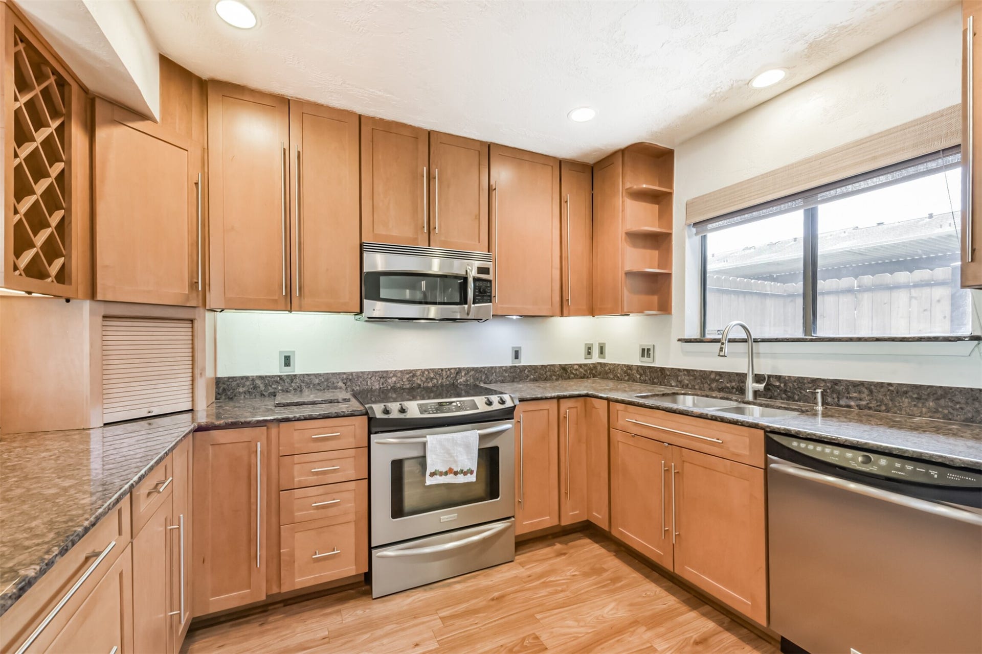 Granite, custom cabinetry with soft close cabinets and drawers, most cabinets have pull out trays, appliance garage and wine rack... they really did think of EVERYTHING!