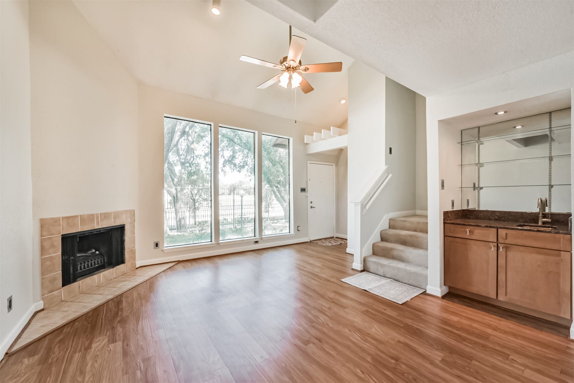 Wood burning fireplace, wood-look flooring throughout the downstairs, fresh paint, lots of natural light all create a light and bright feel yet still warm and welcoming.