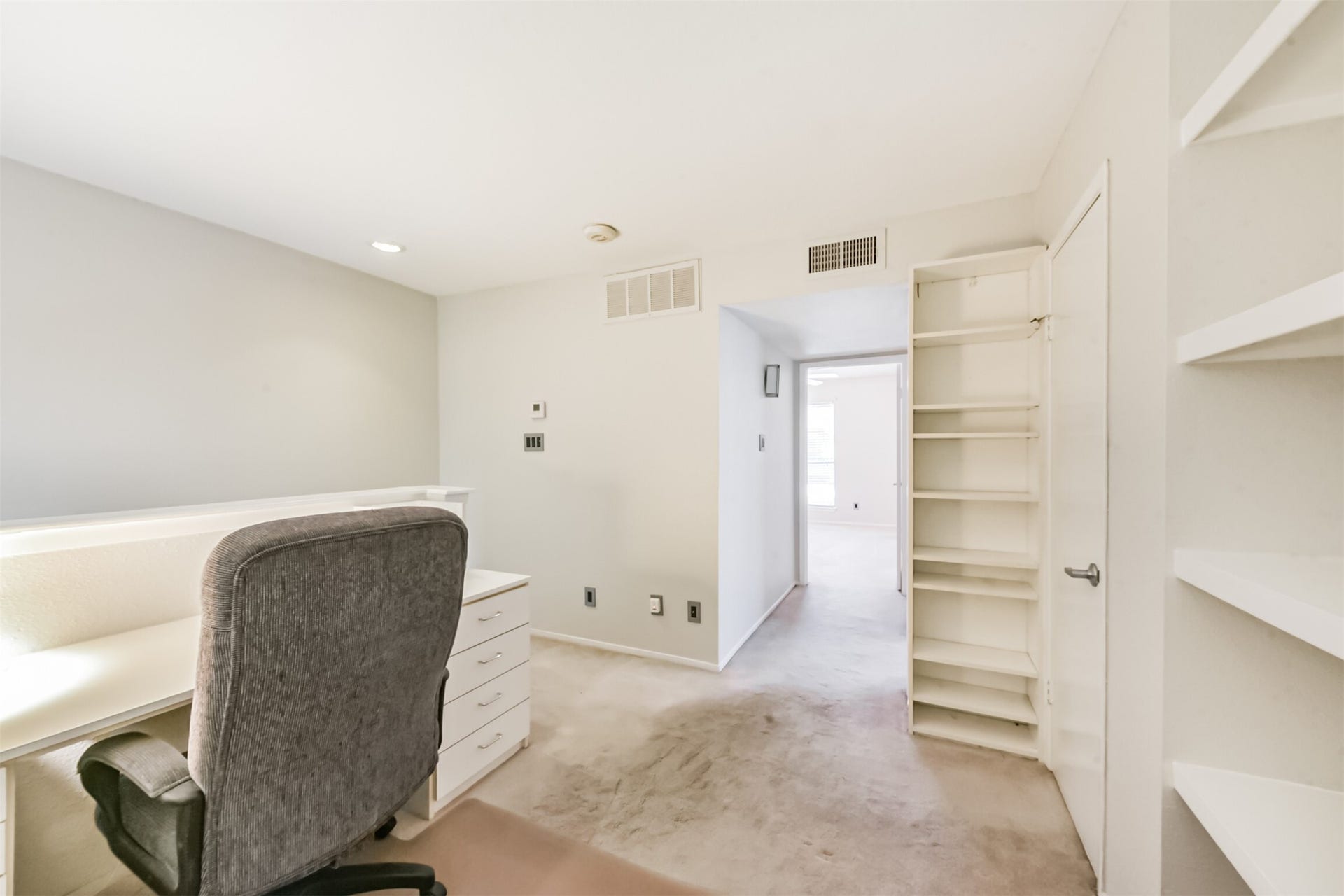 More storage!  Another closet, more shelves and view to hallway and bedrooms.
