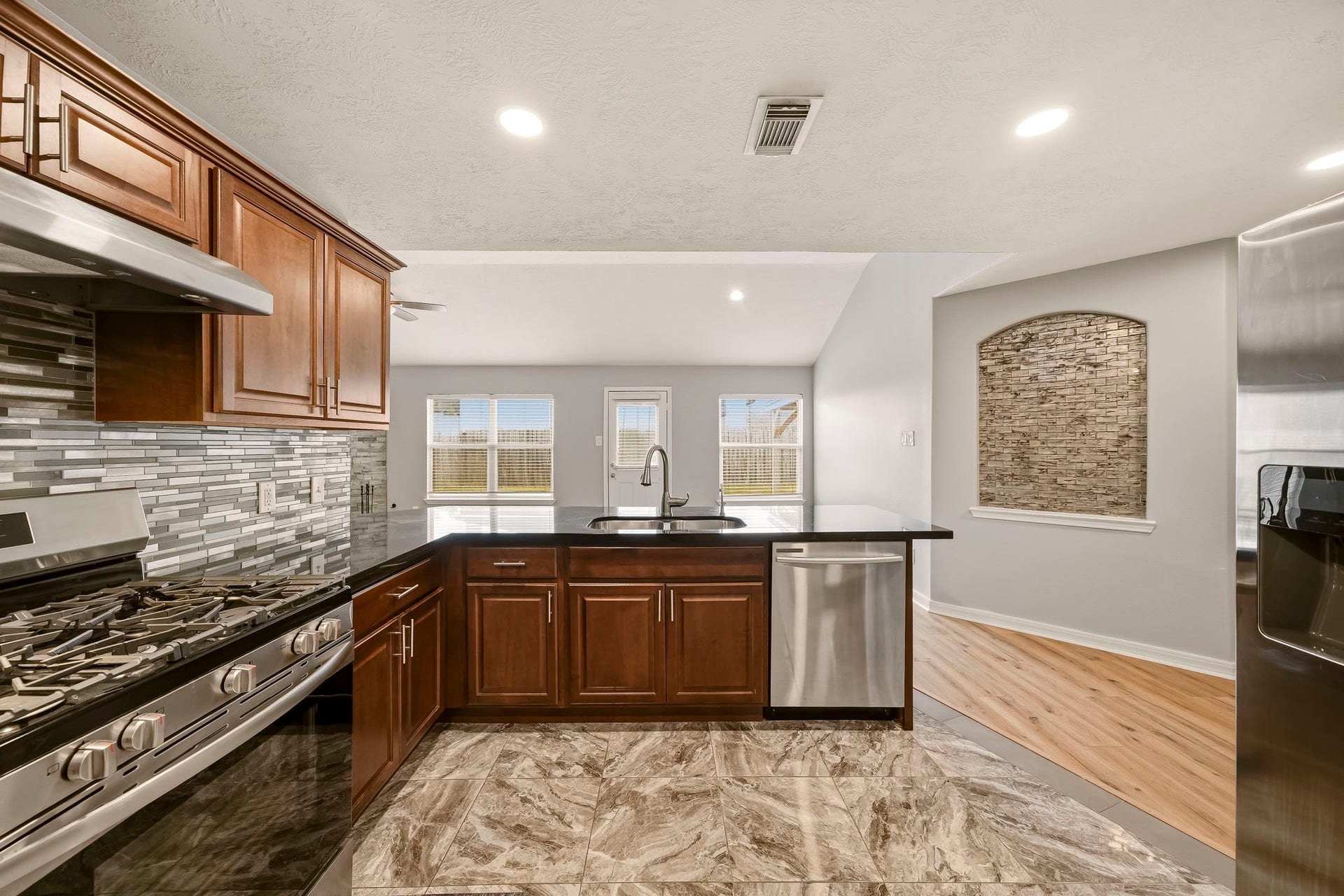 18126 Brightwood Park Lane, Richmond, TX 77407 Renovated kitchen offers ample cabinetry, generous counter space, and recessed lighting.