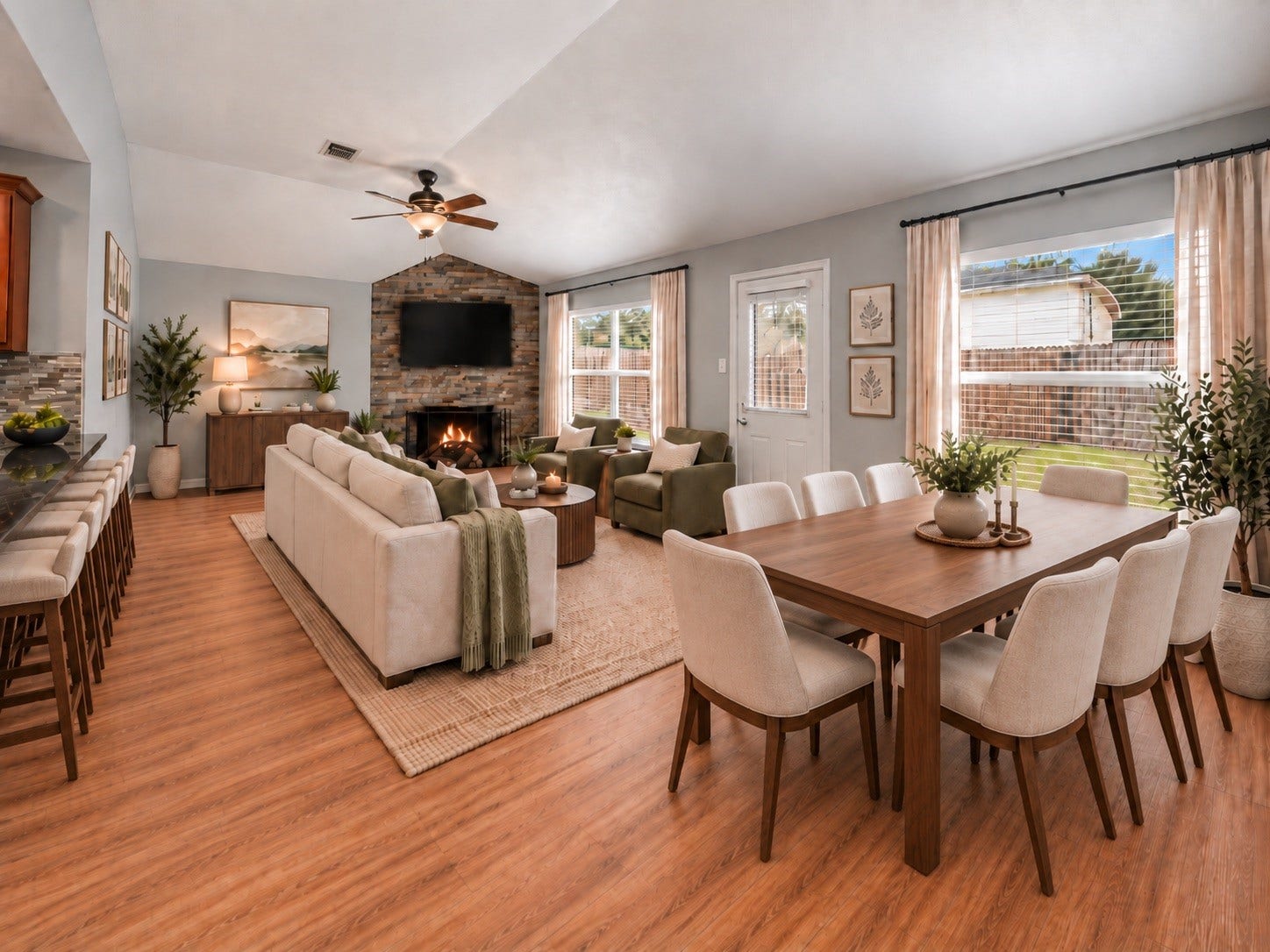 18126 Brightwood Park Lane, Richmond, TX 77407 Virtually staged family and dining area highlights the rooms spacious layout, high ceiling, and fireplace.