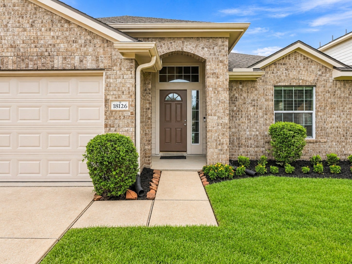 18126 Brightwood Park Lane, Richmond, TX 77407 Covered front entry creates a warm and inviting welcome.