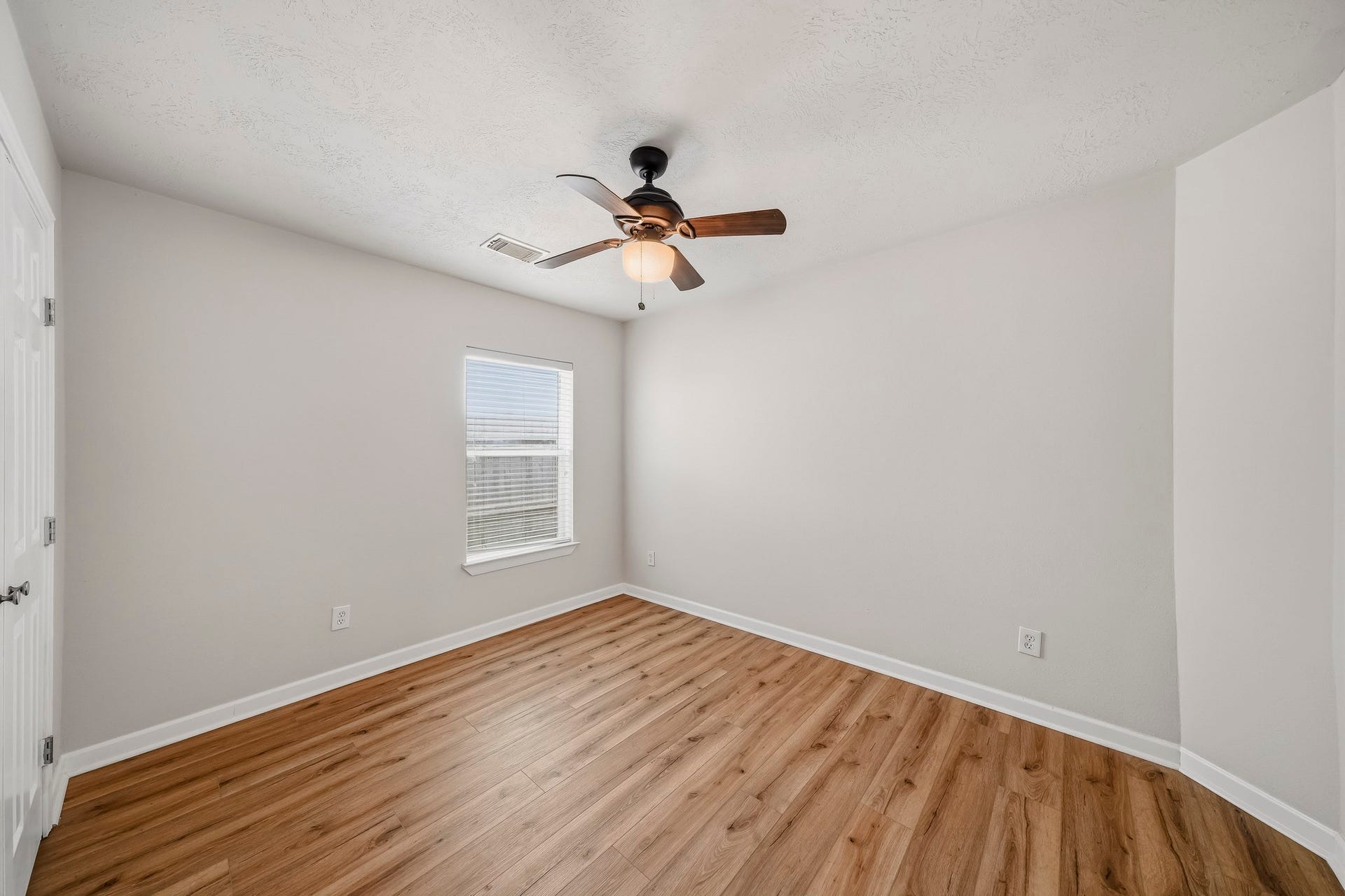 18126 Brightwood Park Lane, Richmond, TX 77407 Secondary bedroom features neutral finishes, warm flooring, and natural light.