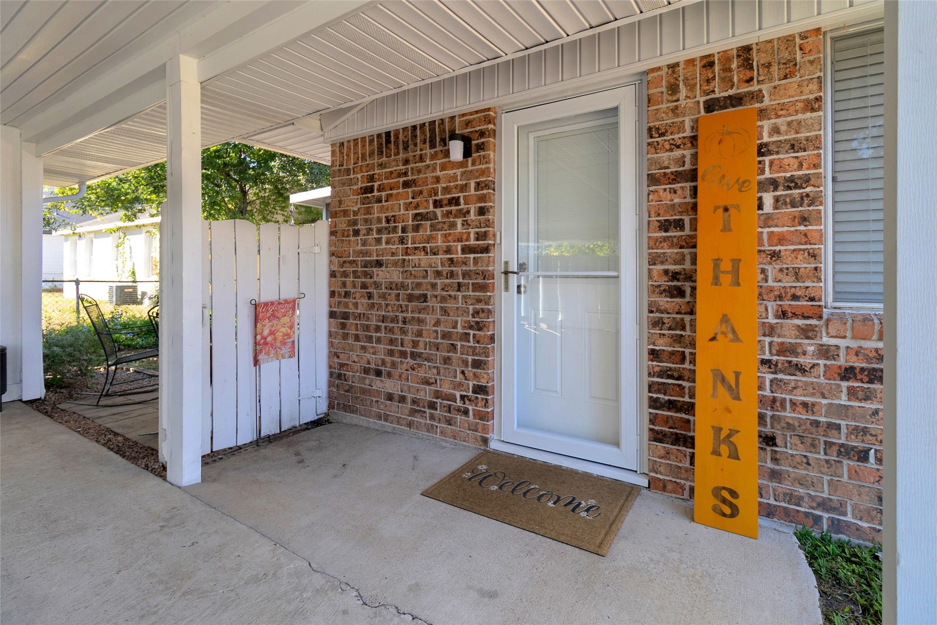 613 N Avenue F, Humble, TX 77338 Charming entrance with a welcoming front door, cozy seating area, and decorative accents, perfect for greeting guests.