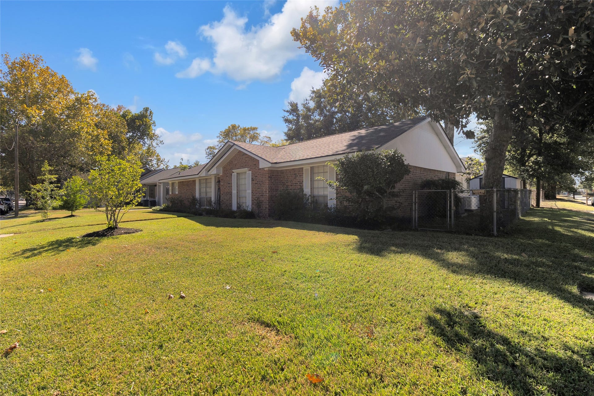 613 N Avenue F, Humble, TX 77338 Closer view of this charming corner lot home, surrounded by mature trees that provide abundant shade and enhance the propertys natural beauty.