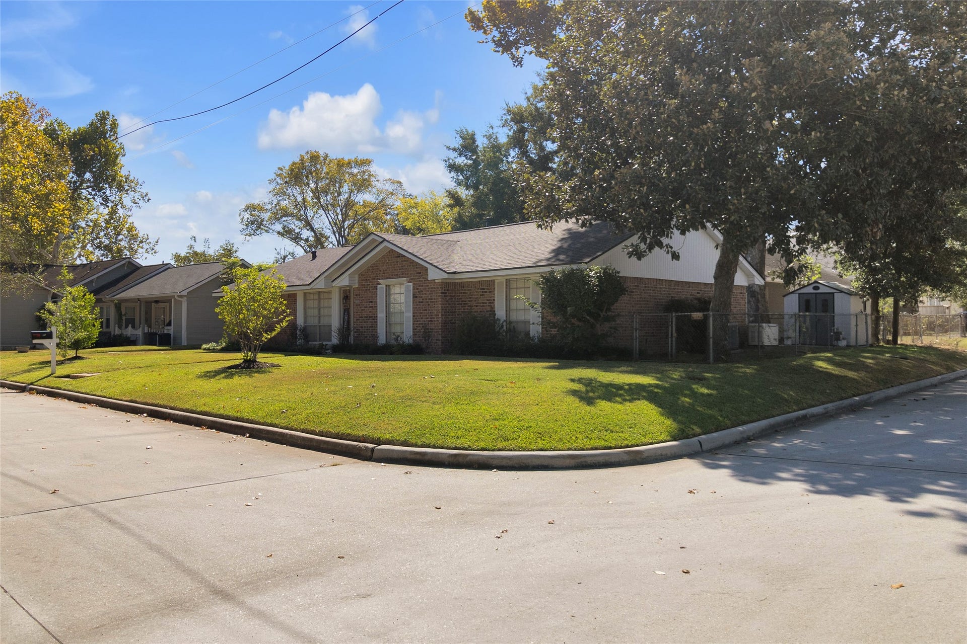 613 N Avenue F, Humble, TX 77338 Beautiful view of this spacious corner-lot property, showcasing its inviting curb appeal and expansive outdoor space.