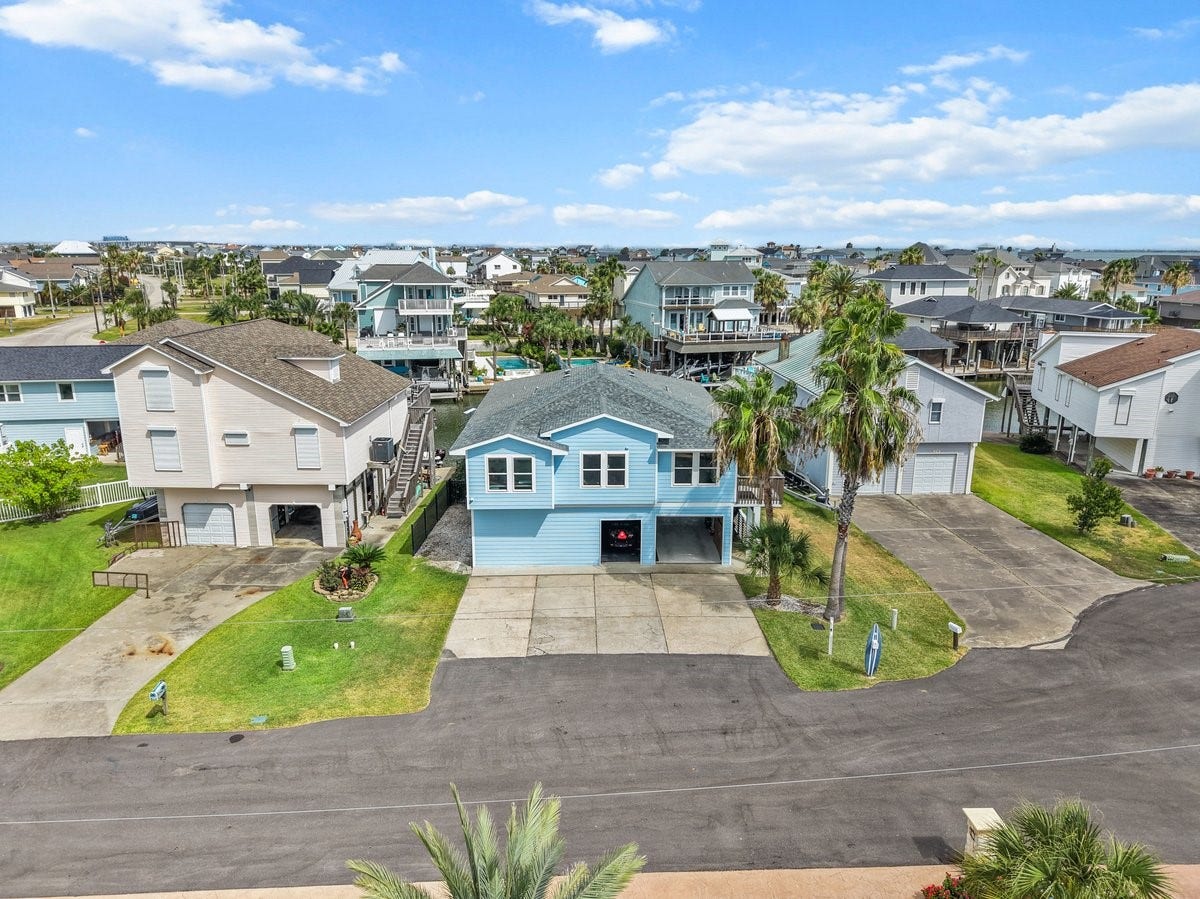 Welcome to your Bright and Breezy Coastal Retreat! Stunning Coastal Blue Stilt-Home stands out with its fresh Modern Exterior!