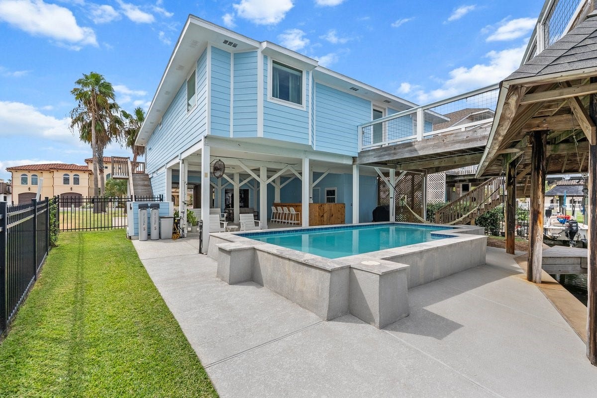 Back of home is true Resort Living! This area is designed to be the Ultimate Entertainment Hub, offering both Private Cocktail Pool with Direct Water Access!