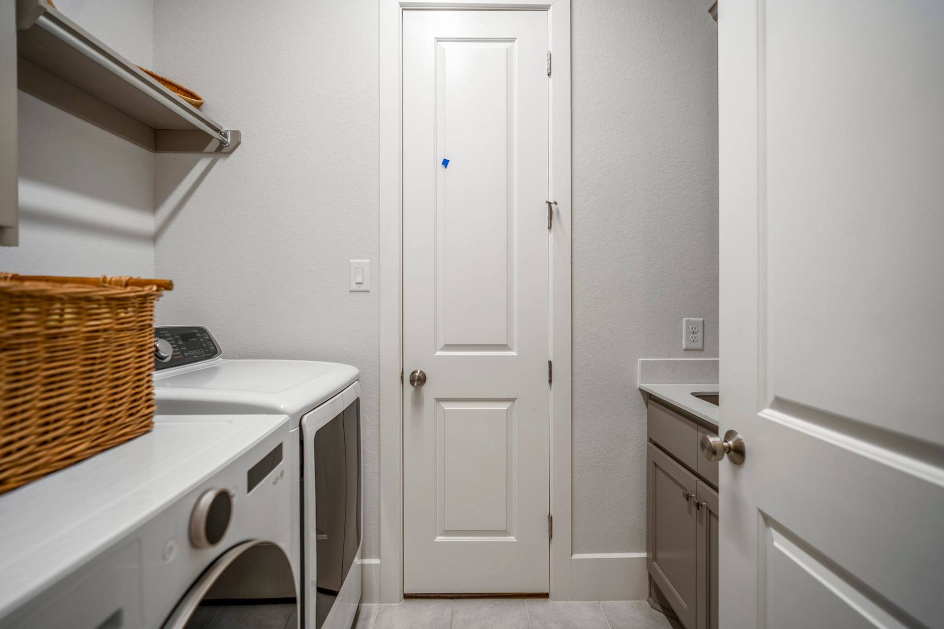 The laundry room with a sink with cabinets.  And there's a surprise...