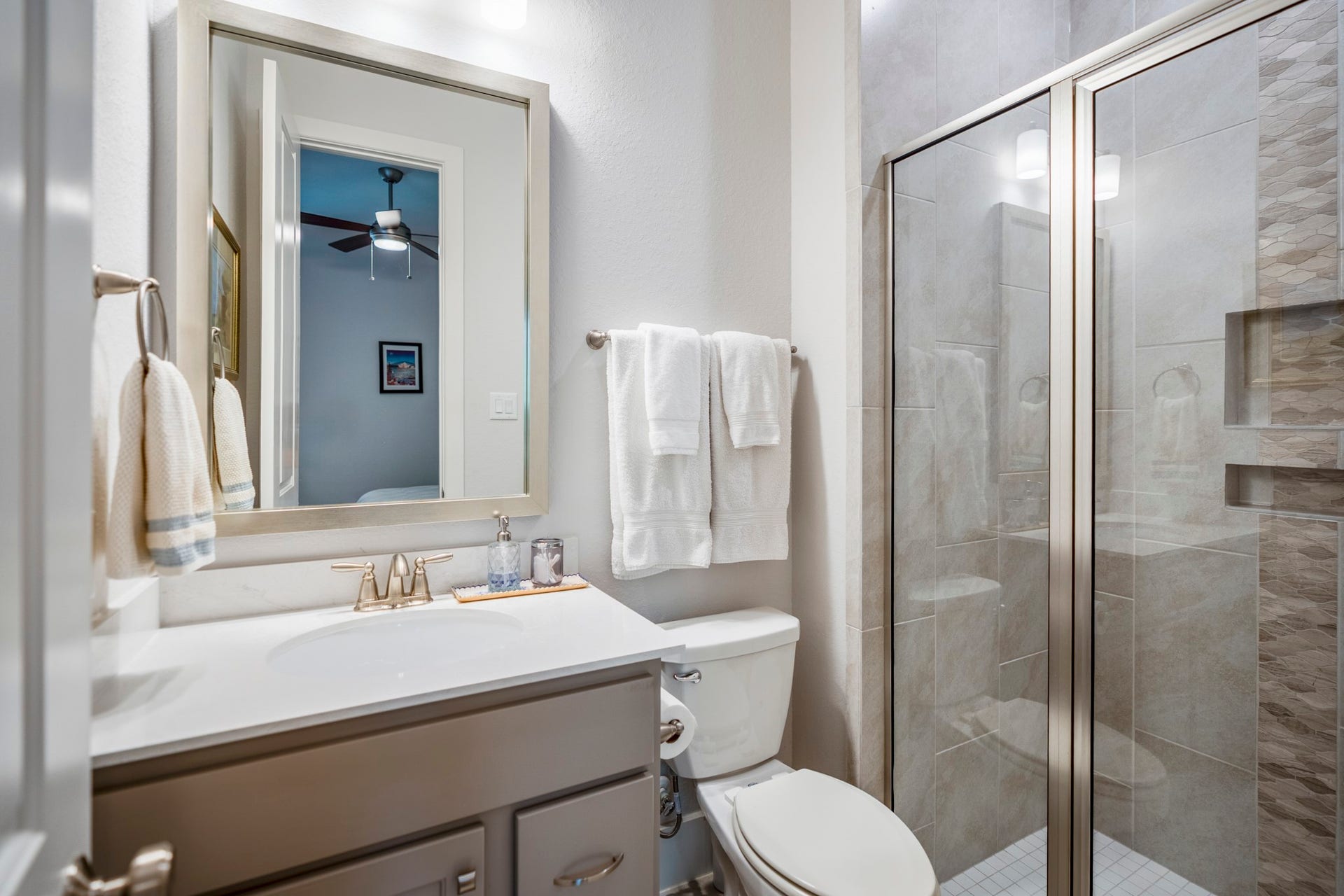 This secondary full bath is located downstairs, with an easy access shower.