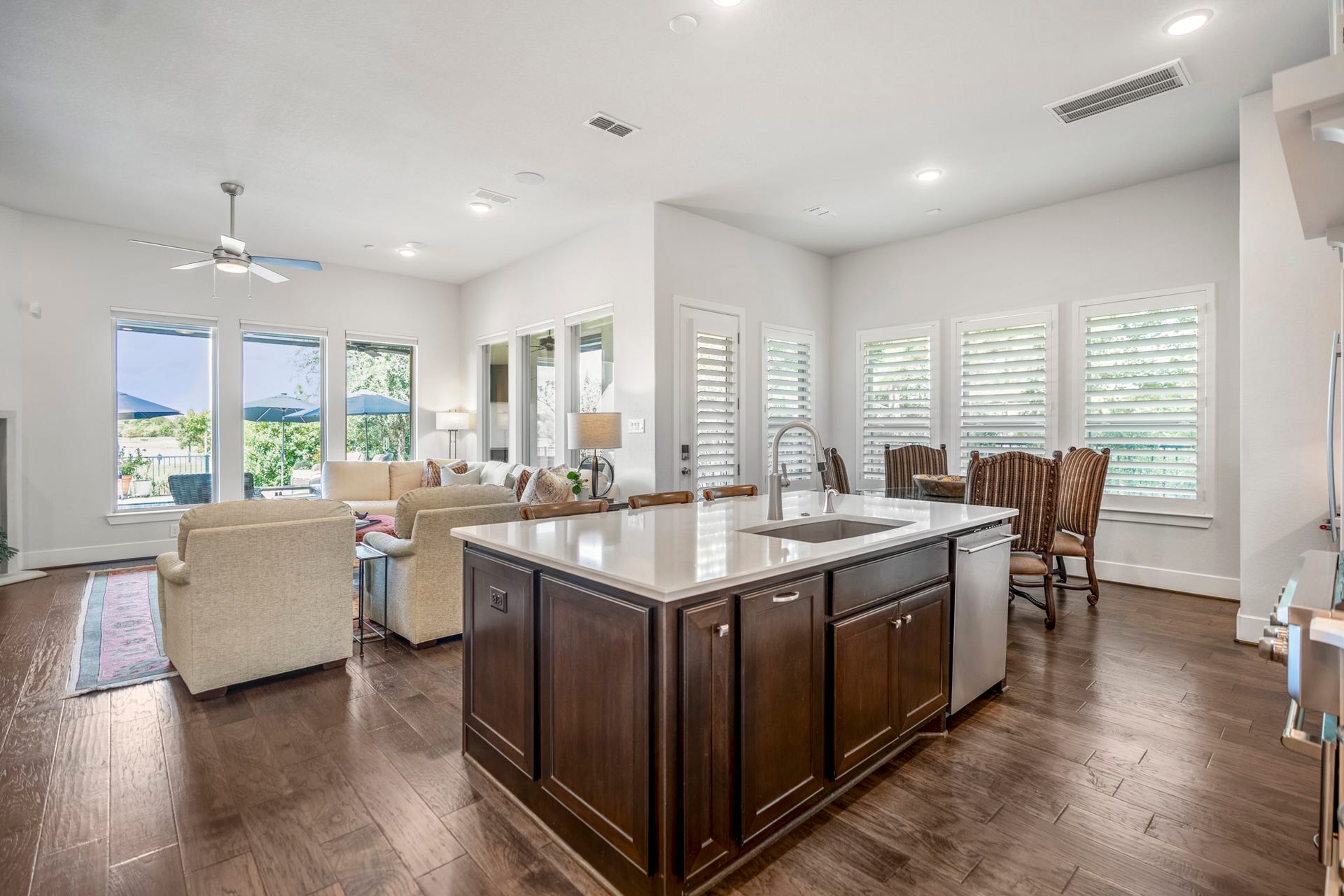 The heart of the home, the kitchen, breakfast room, and living room.  LED lighting adds a gentle glow, and picture windows show the waterfront view.