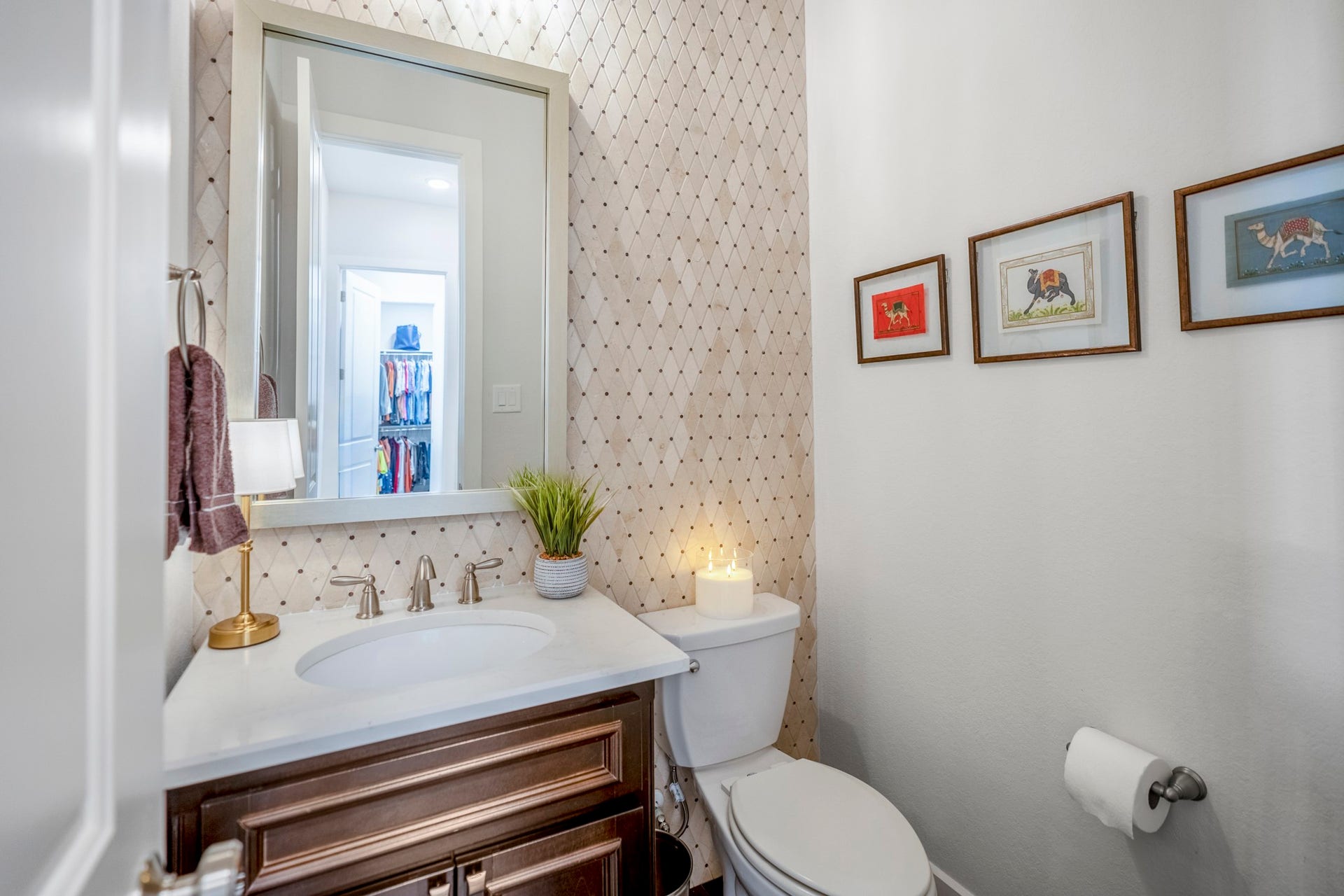 The guest bathroom is off the dining room area and main entryway. An accent wall of tile Is a nice touch.