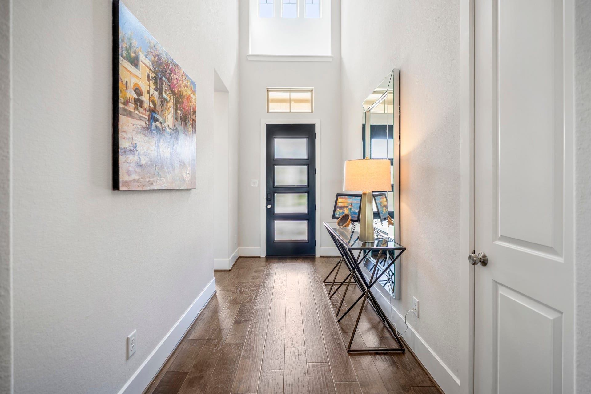 The elegrant main entry, with soft light coming in from the door and windows above.