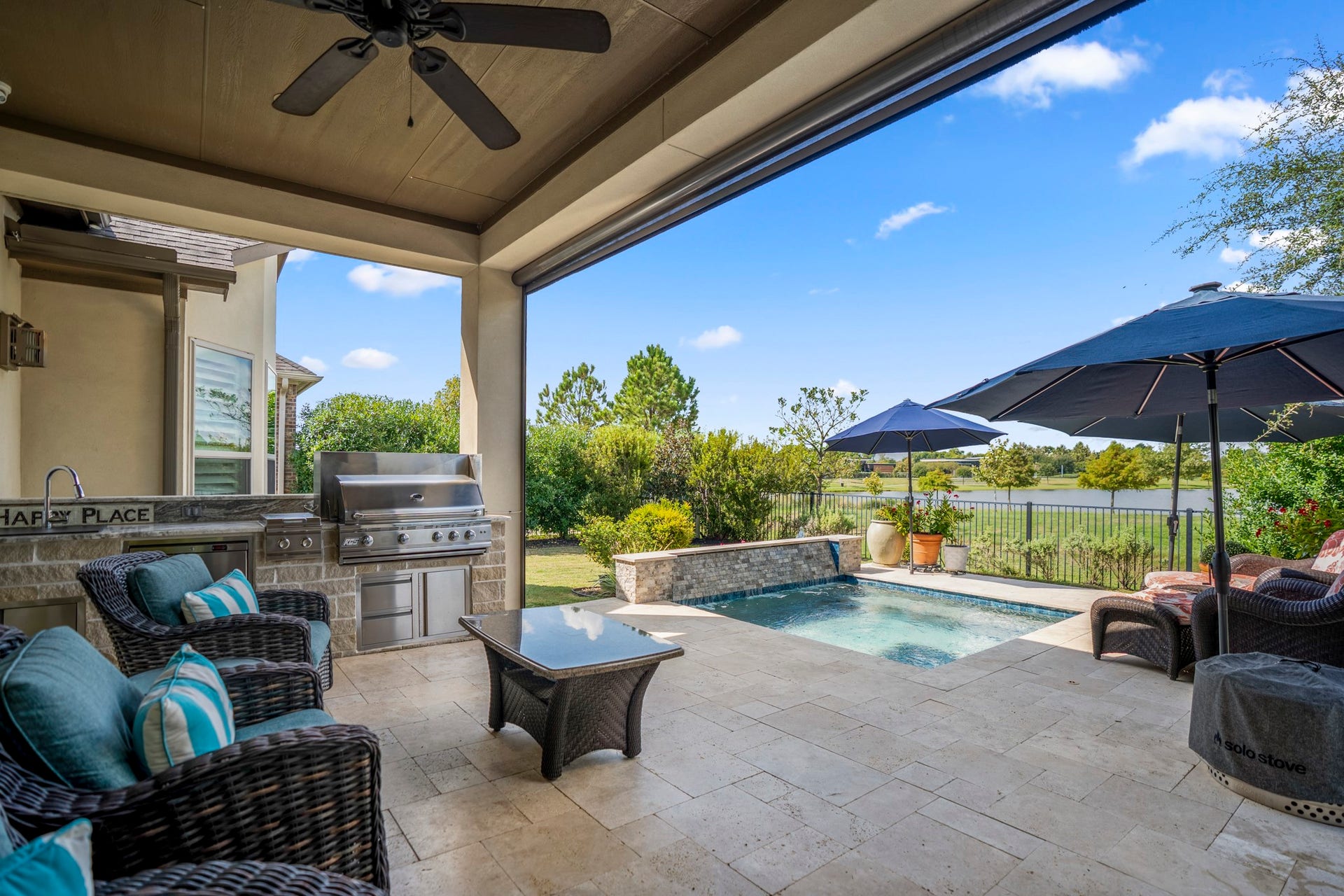 Enjoy the outdoor kitchen with grill, side burner, sink and fridge