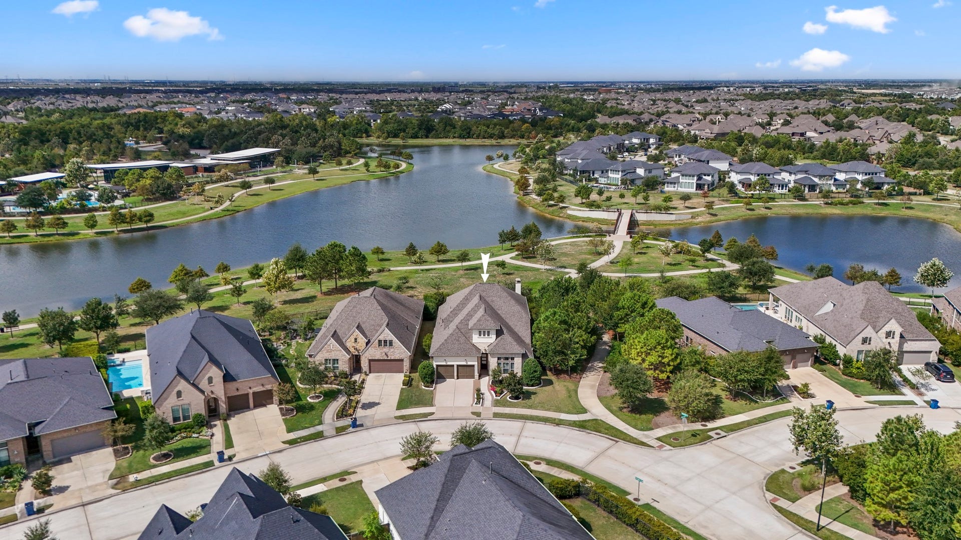 Bird-s eye view of the home, and the lake beyond.