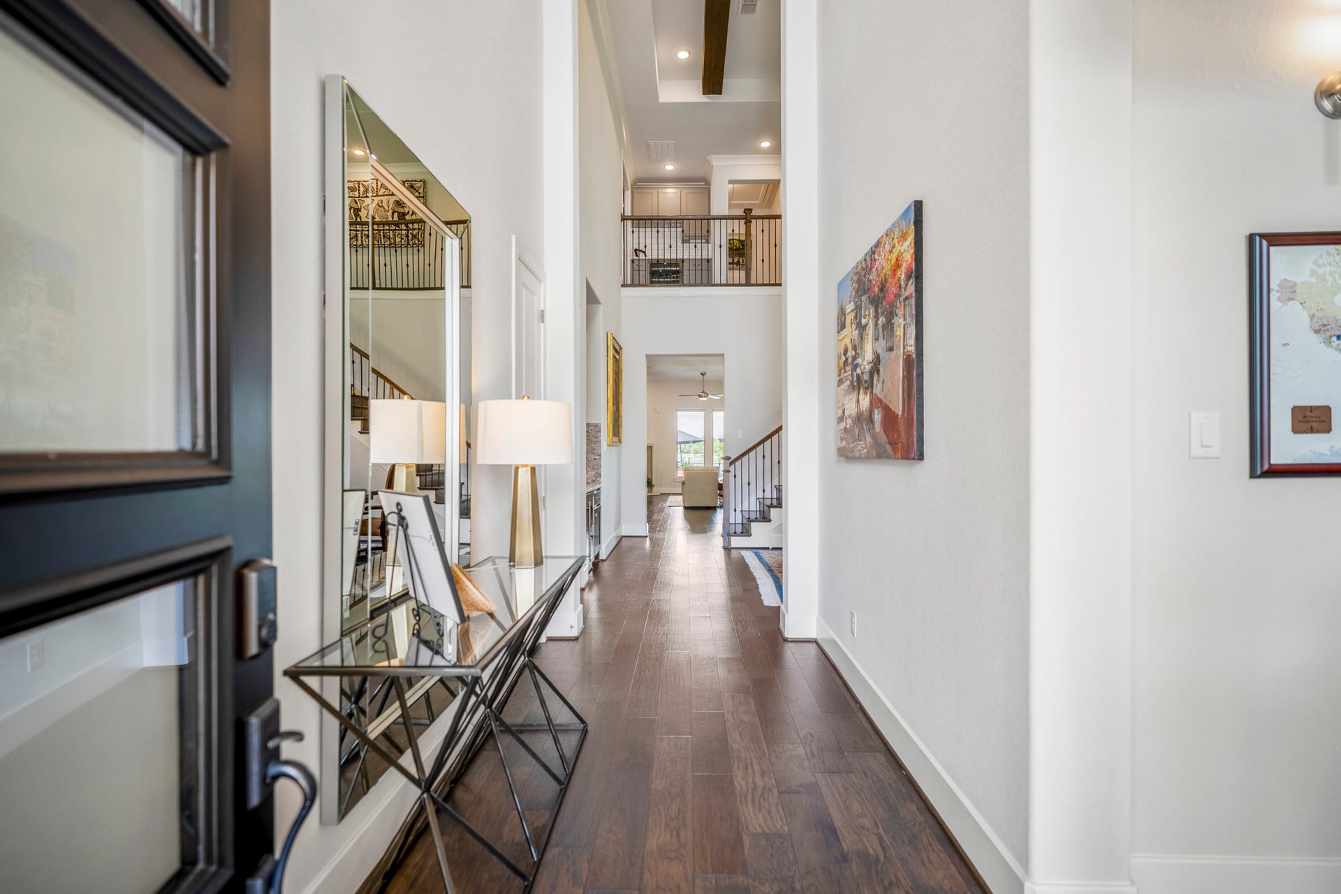 Warm wood flooring and soaring ceilings guide you into the home.  The whole first floor is solid surface flooring, no carpet.