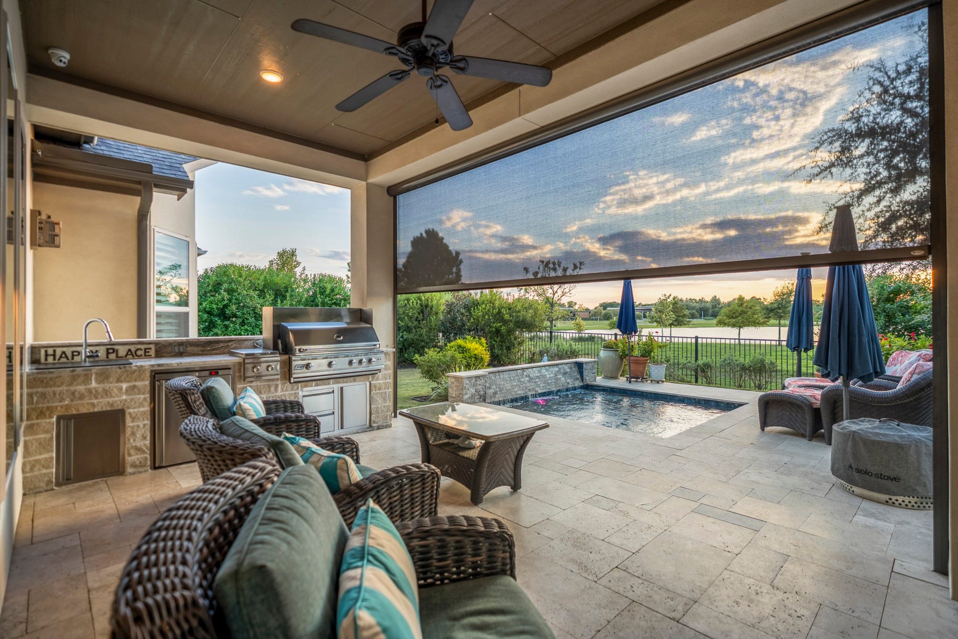 And now...the VIEW!  The covered patio and outdoor kitchen, with wood accented ceiling for a warm feeling.  The electric shade can block up to 95% of the light if needed.