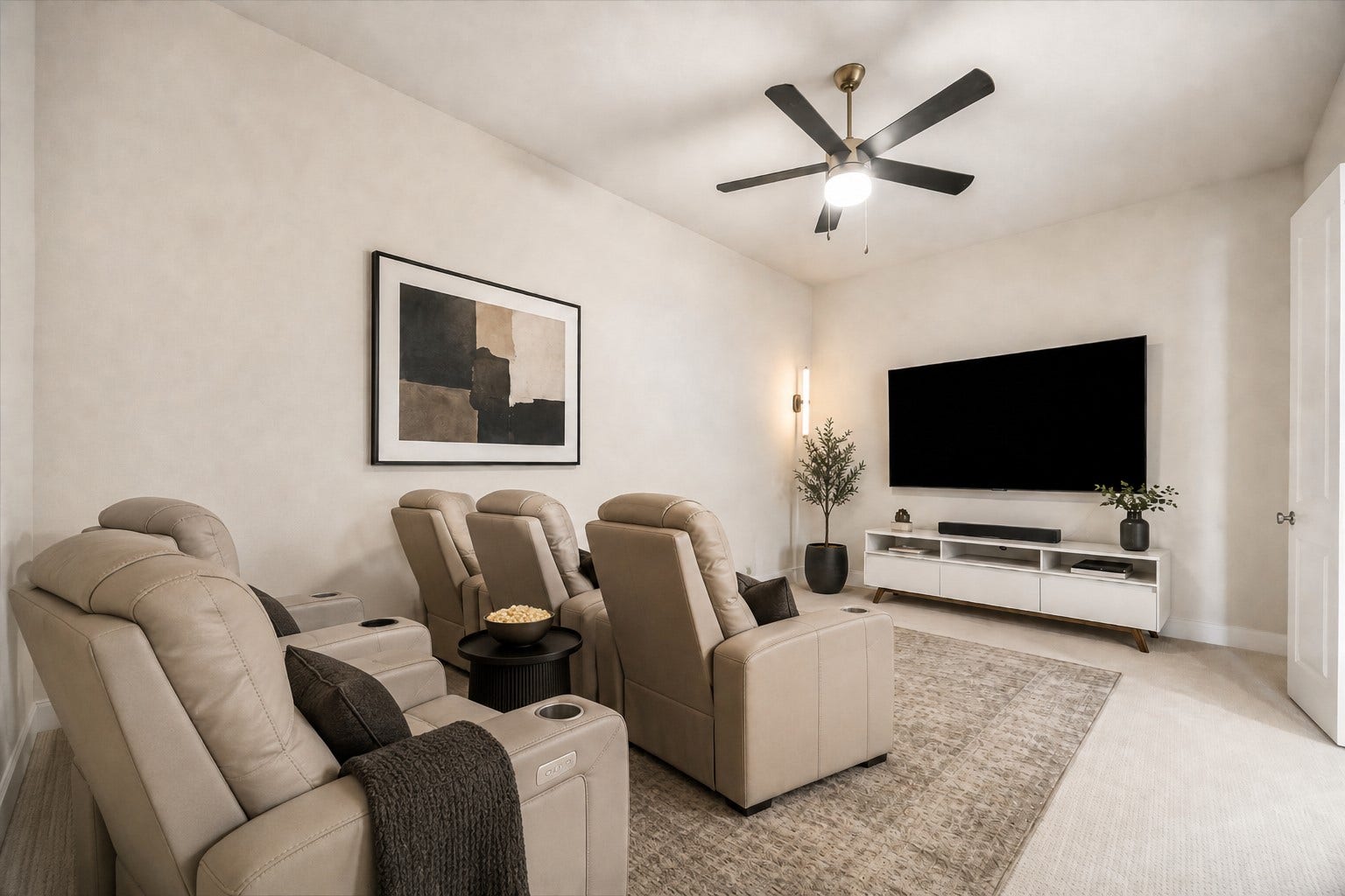 FIRST FLOOR ENTERTAINMENT ROOM OFFERS A GENEROUS LAYOUT, CEILING FAN, AND WALL SPACE IDEAL FOR A LARGE-SCREEN ENTERTAINMENT SETUP. **Virtually Staged.