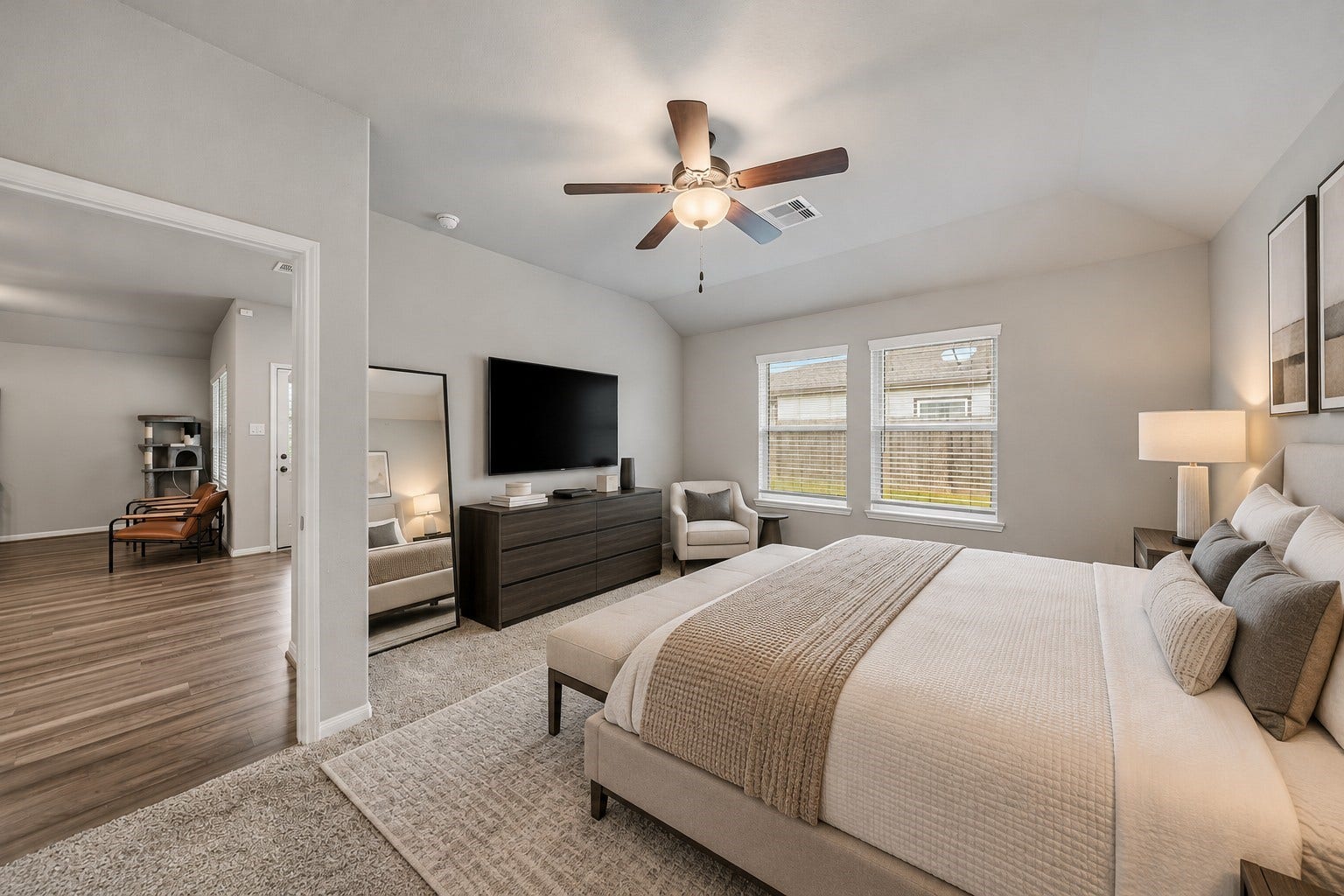 903 Pismo Lane, Rosharon, TX 77583 Virtually Staged: This spacious primary bedroom features vaulted ceilings, and plush carpeting that creates a warm, inviting atmosphere. Two large windows allow abundant natural light to fill the space, enhancing its bright and airy feel.