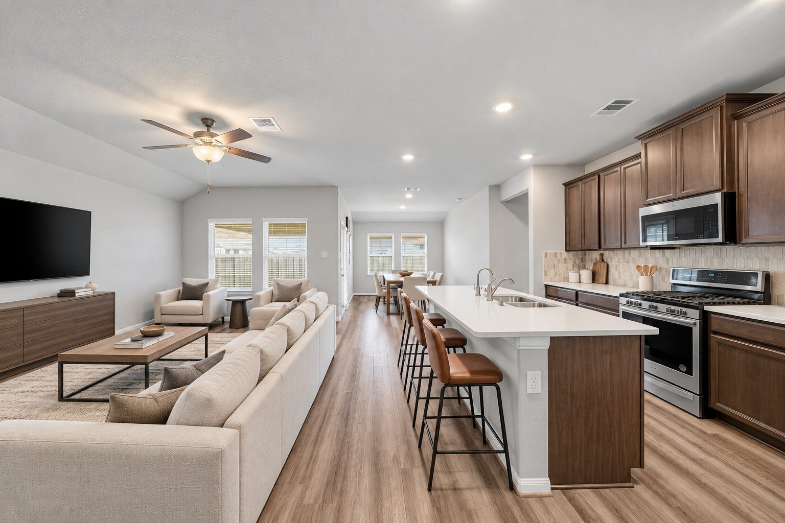 903 Pismo Lane, Rosharon, TX 77583 Virtually Staged: This spacious open-concept living area seamlessly connects the kitchen, living room, and dining space, creating an inviting layout ideal for everyday living and entertaining.