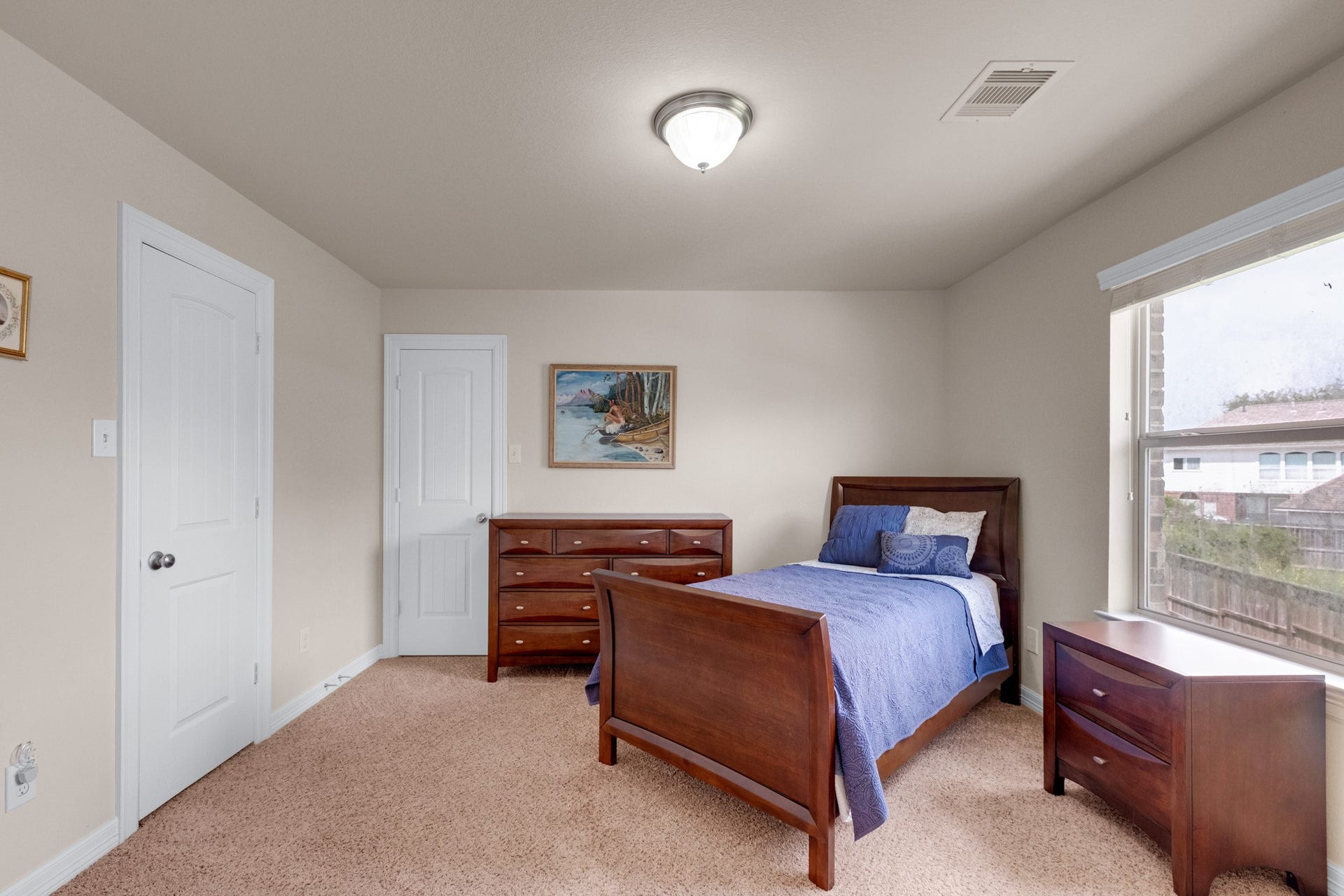 440 Old Orchard Court, Dickinson, TX 77539 Another secondary bedroom carries plush carpet, a full window, and enough wall for a queen or twin set with dressers.